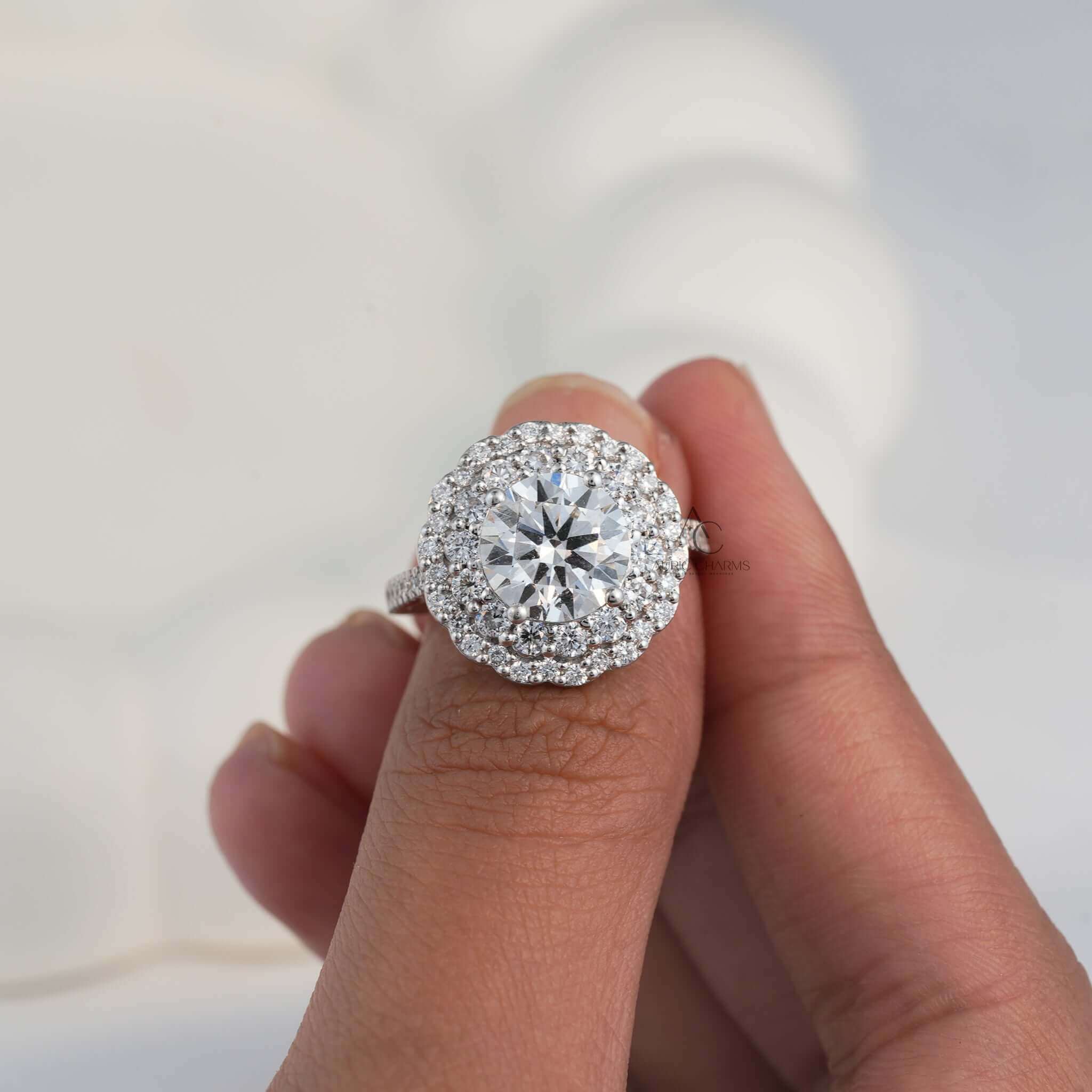 Lab-grown diamond floral halo ring with multiple rows of diamonds in hand.