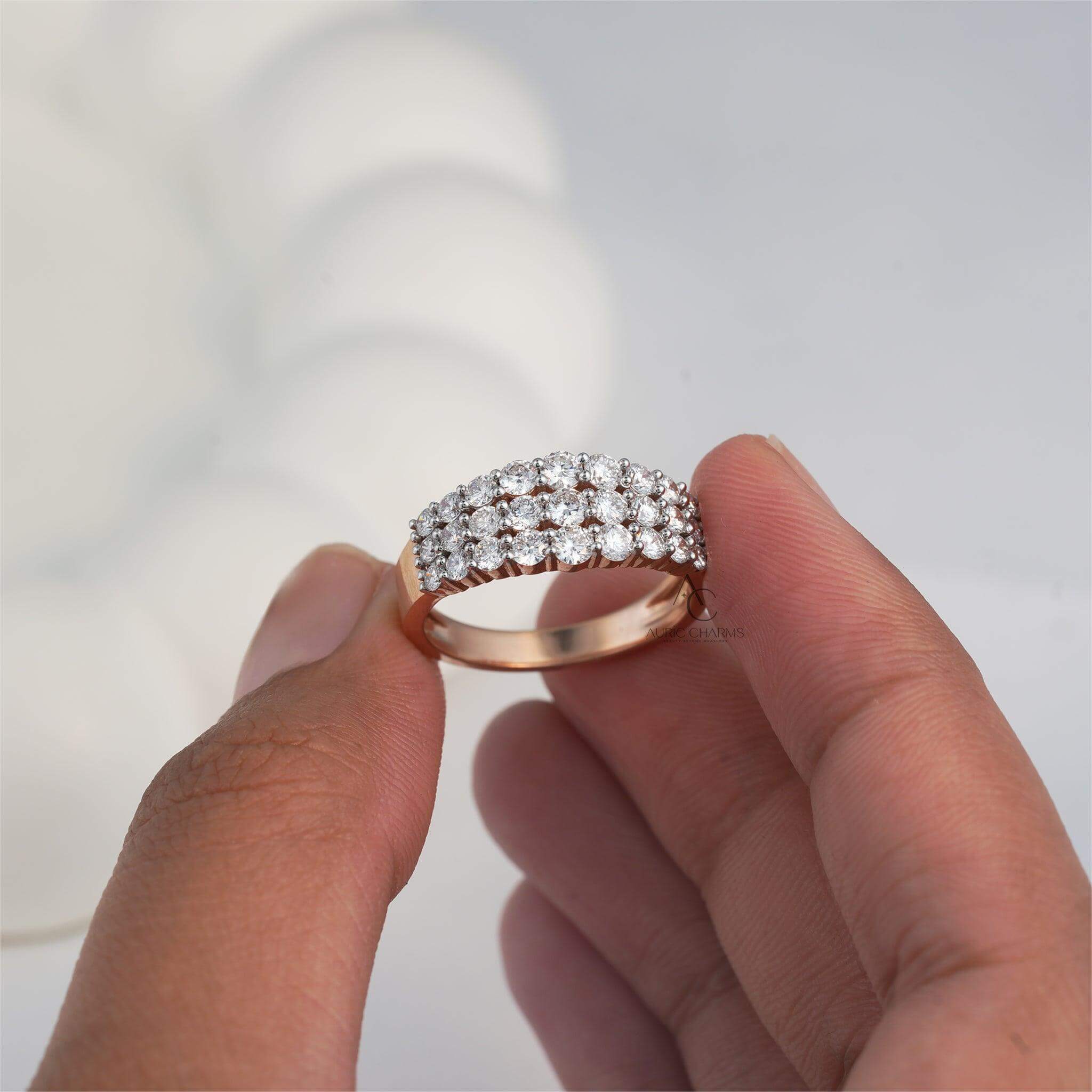 Close-up view of three-row lab-grown diamond ring, held delicately for clarity.