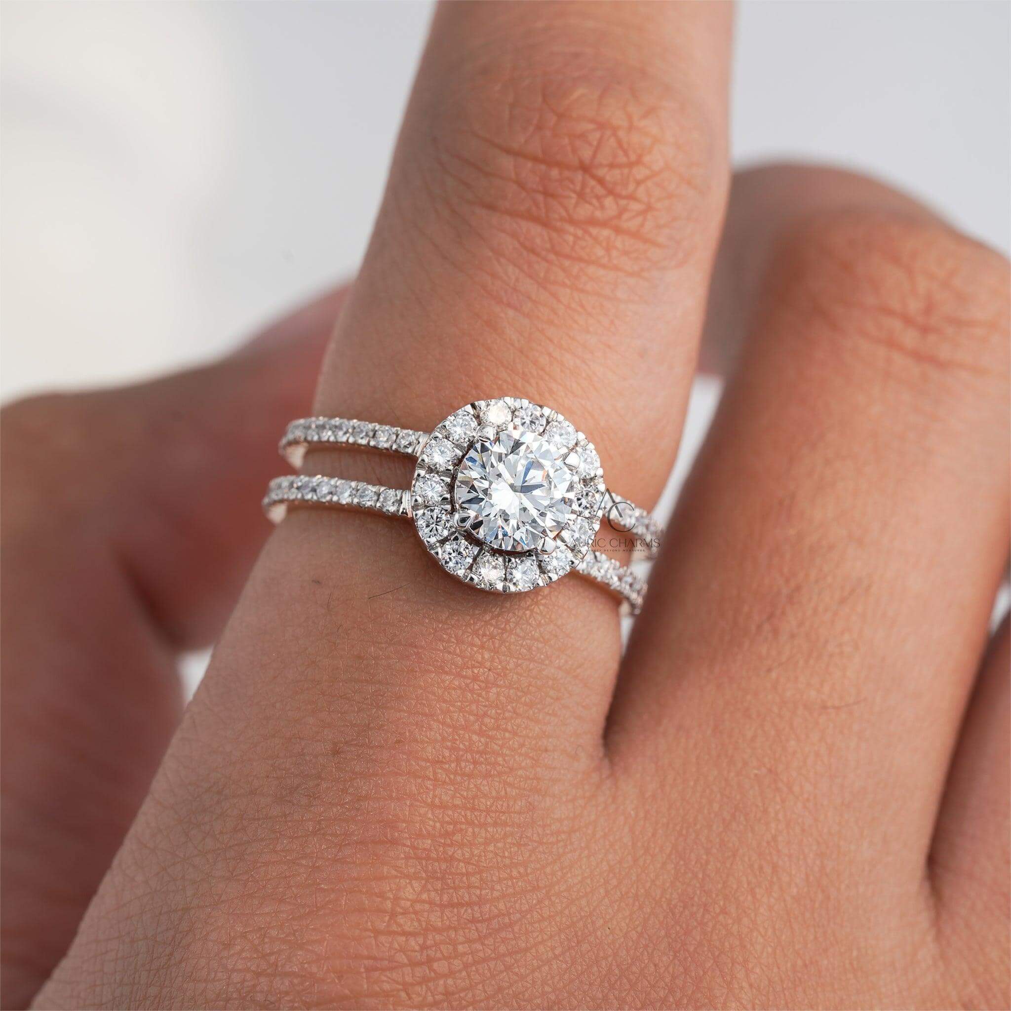 Elegant round-cut diamond ring set with a double halo of smaller diamonds, featuring a split shank design, displayed on a hand for perspective.