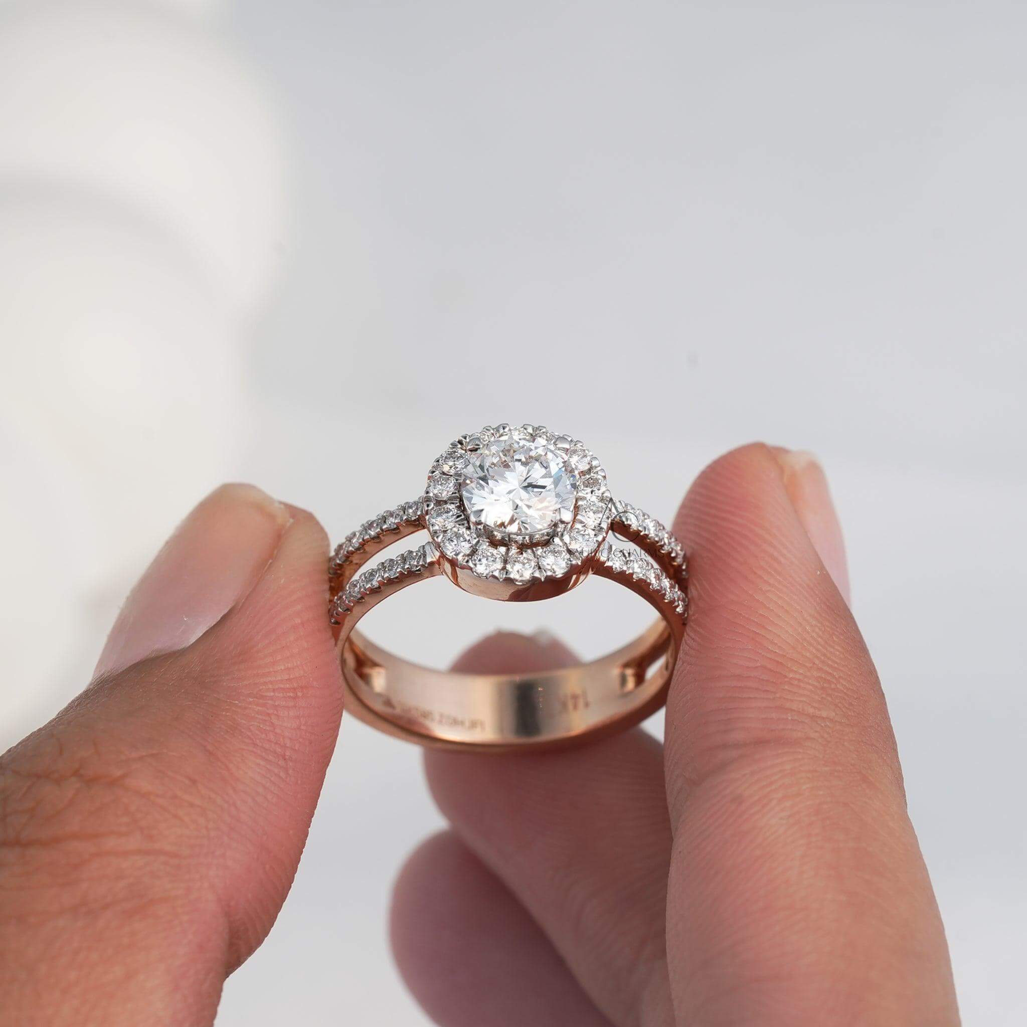 lose-up of a round-cut diamond ring with a halo of smaller diamonds and a rose gold band, highlighted against a neutral background.