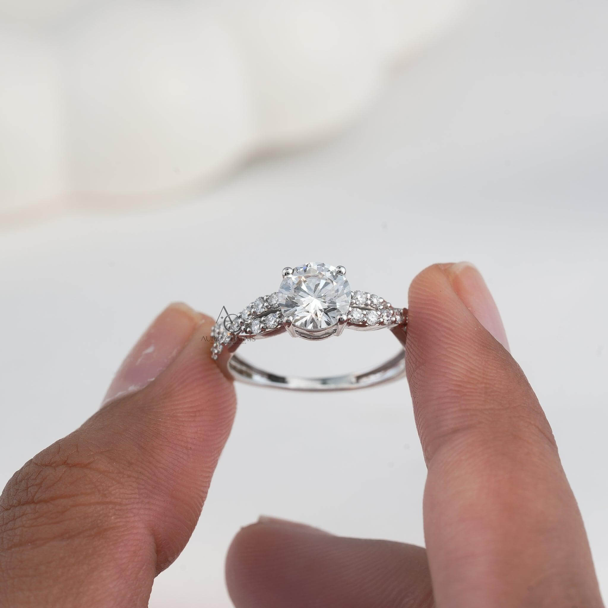 Single band diamond ring with delicate braided detailing, held gently.