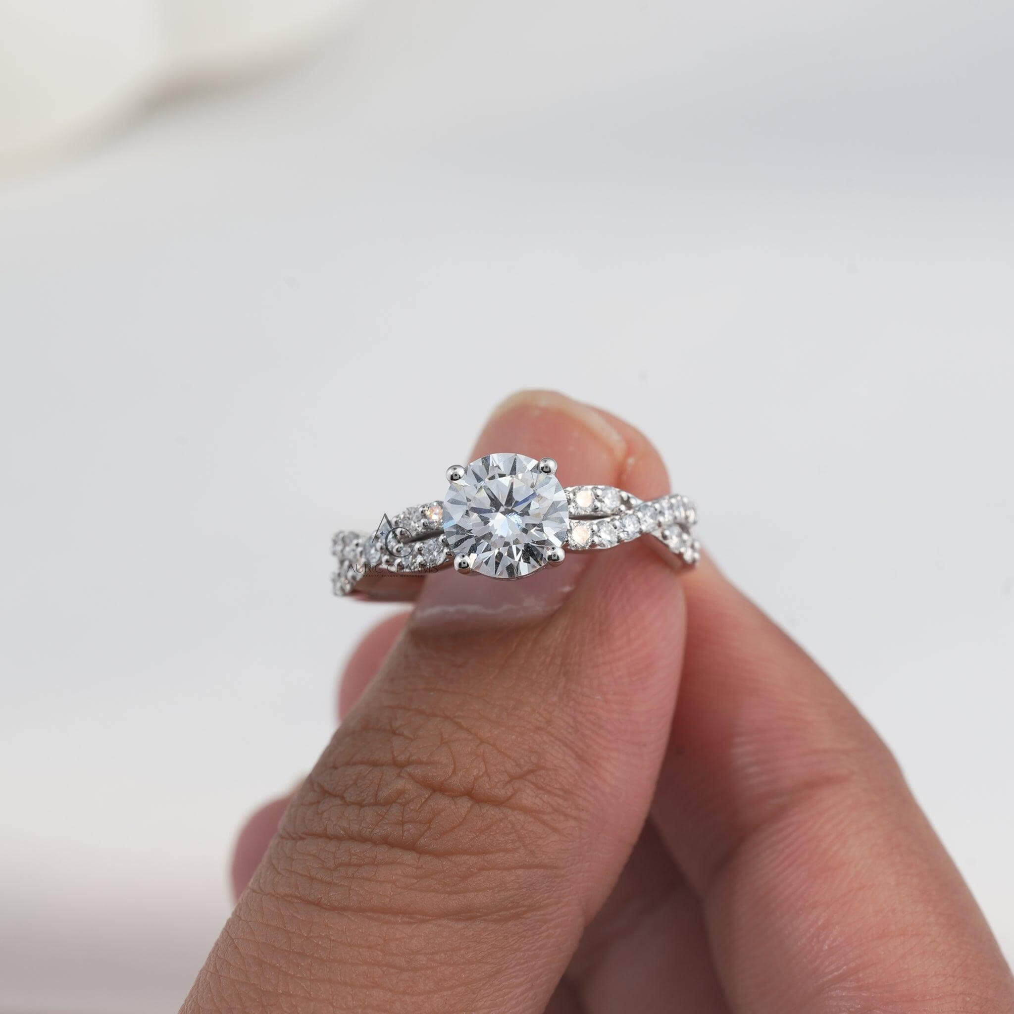 Detailed view of a solitaire diamond ring featuring a modern twist-style band