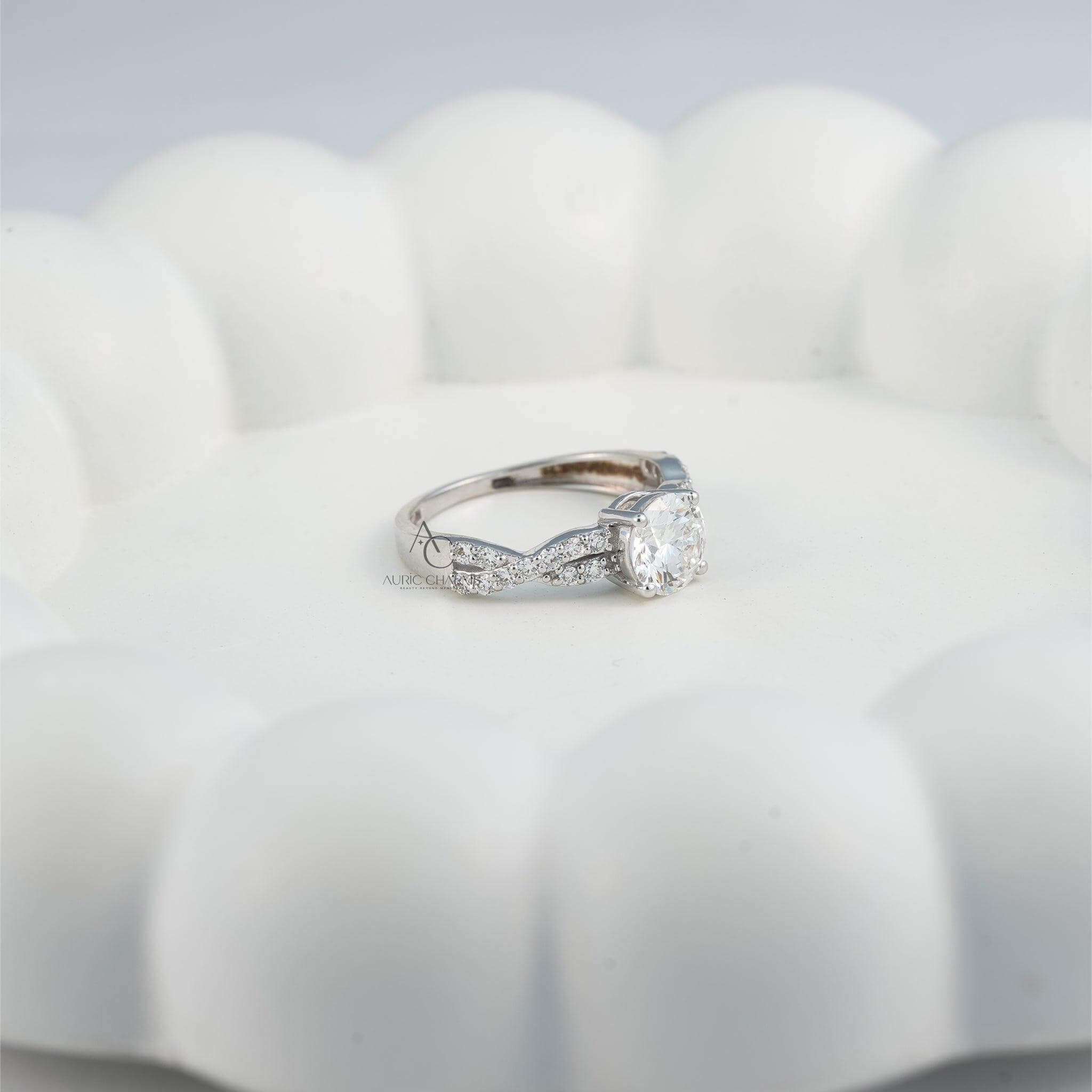 Solitaire diamond engagement ring with a twisted diamond band on a hand.