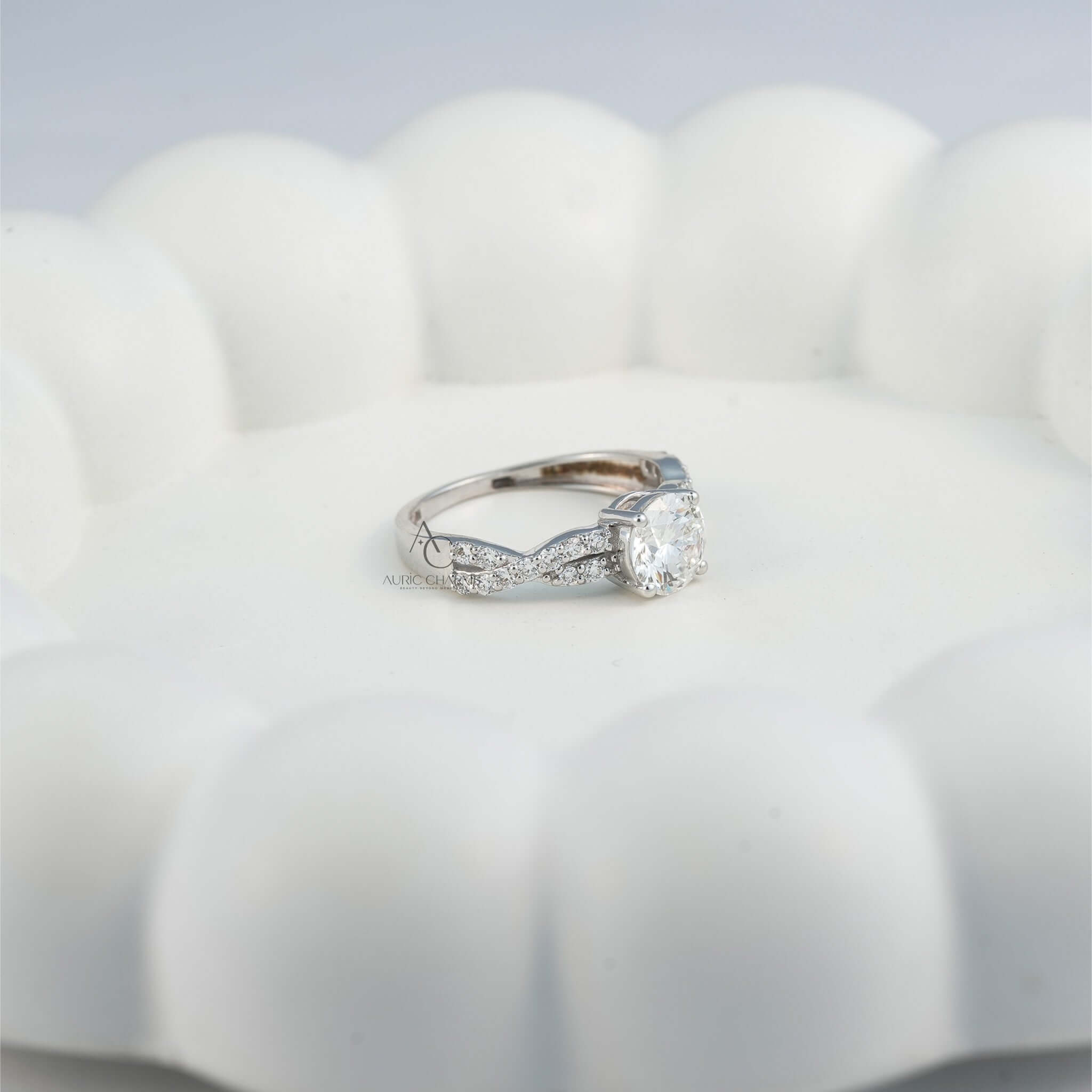 Side view of diamond ring with twisted band and pave setting on display.