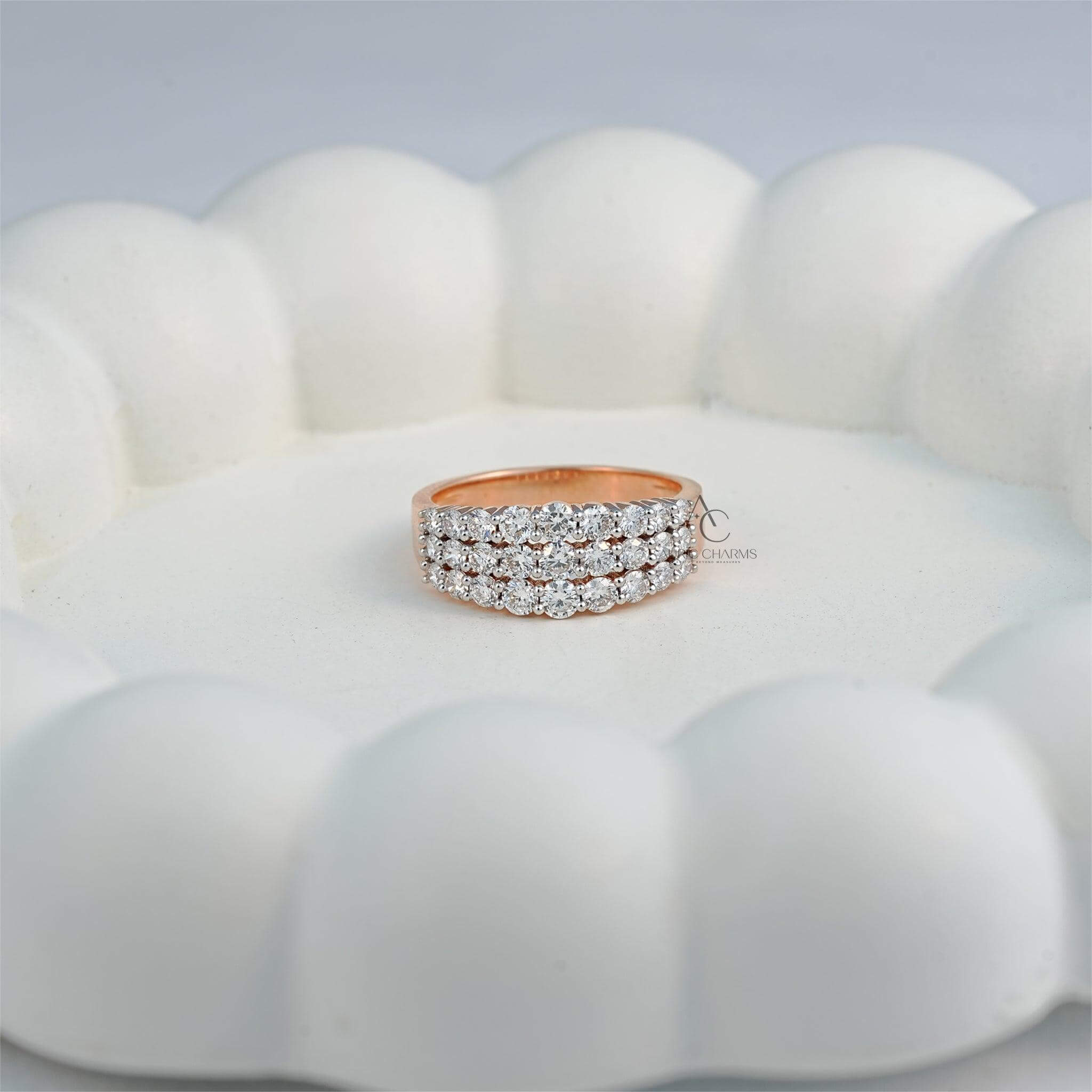 Lab-grown diamond ring with three rows, resting on a decorative surface.