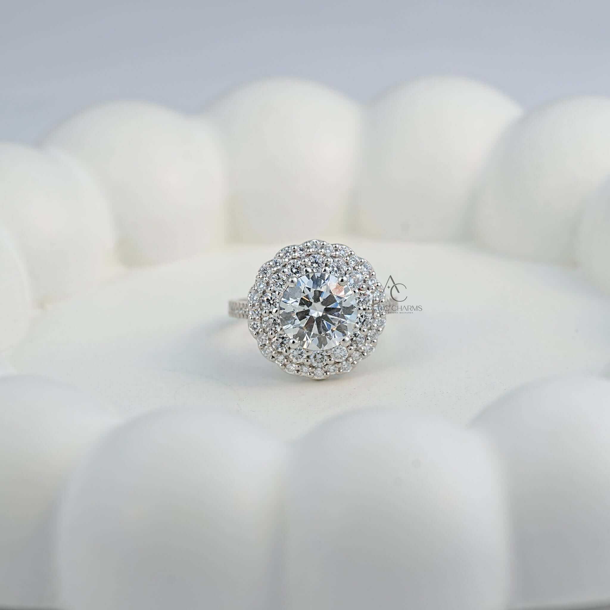 front view of lab-grown diamond floral halo ring on a decorative white surface.