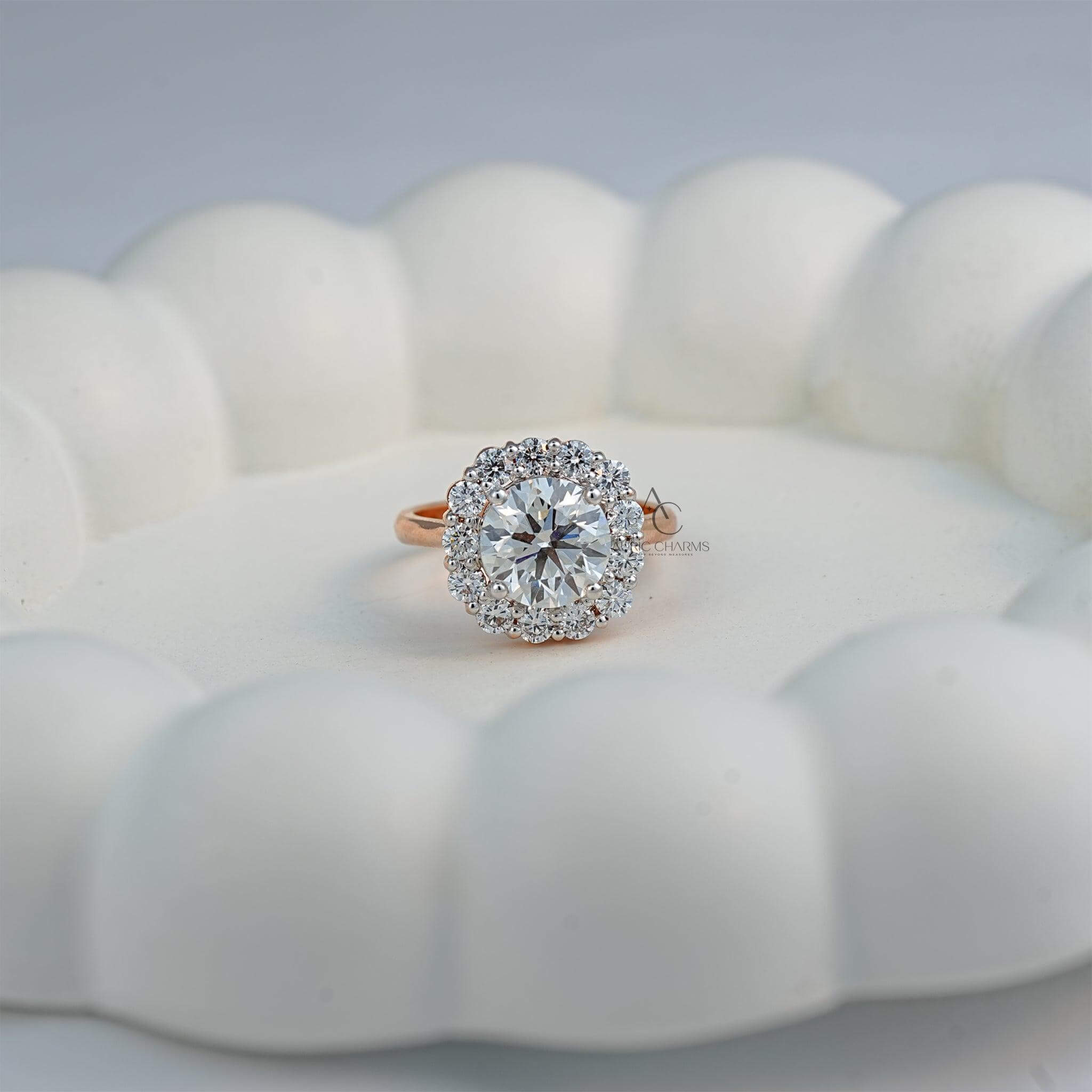 Round halo engagement ring displayed on a decorative white surface, enhancing its brilliance.