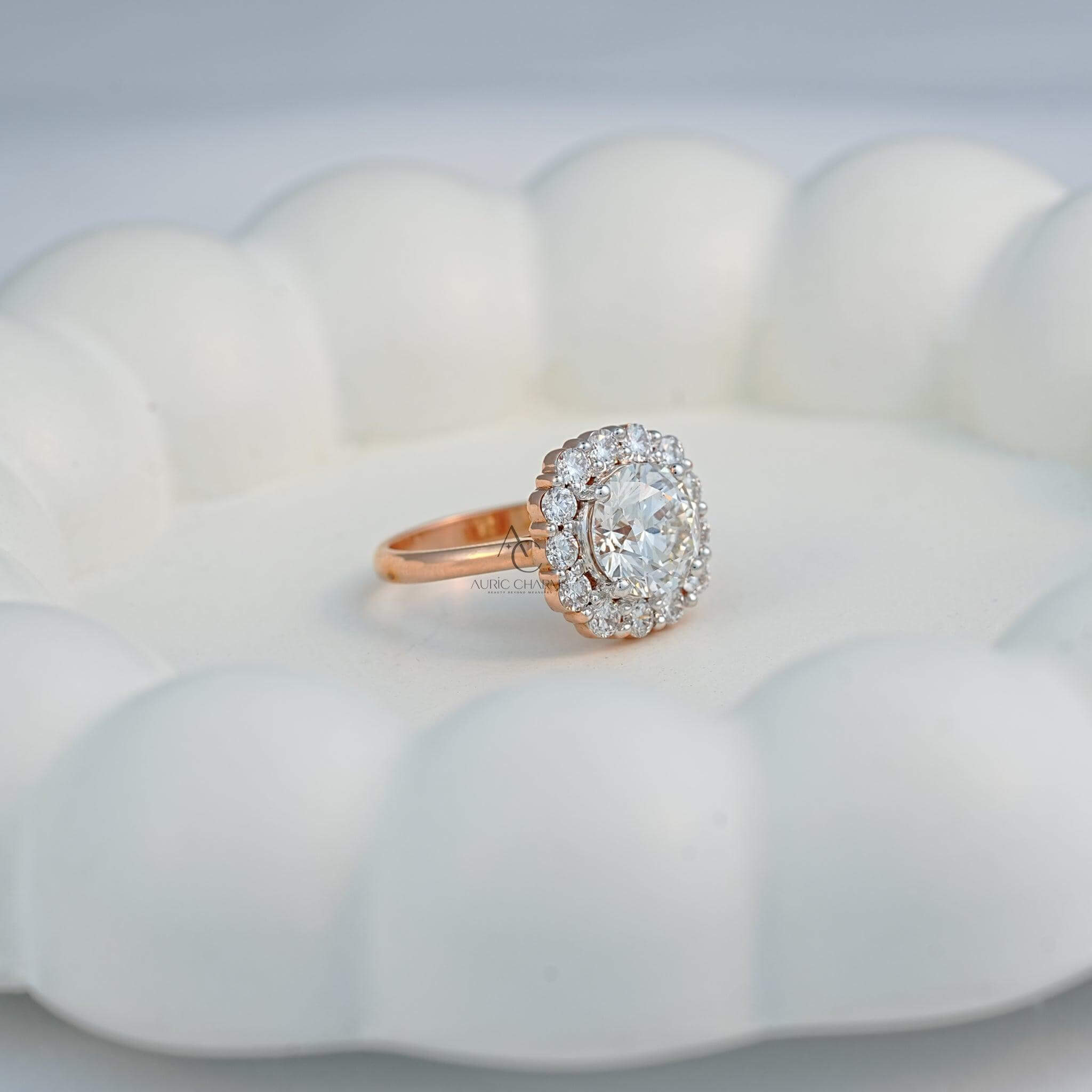 Elegant halo diamond engagement ring in a classic round design on a white decorative setting.