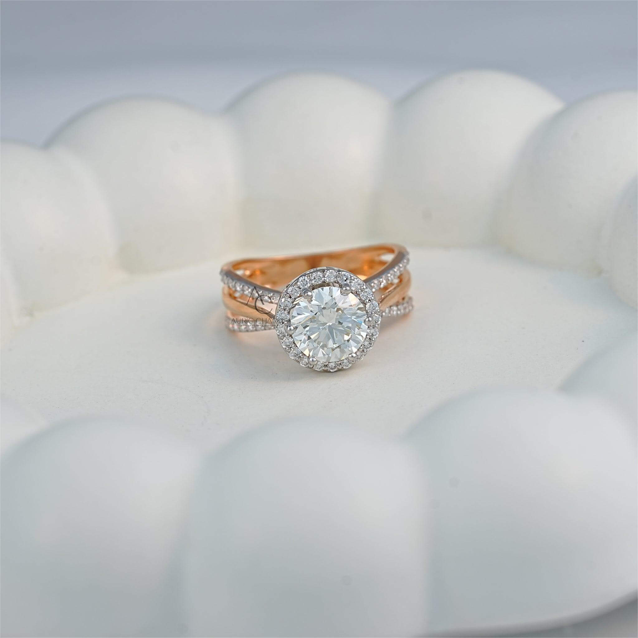 Round halo diamond engagement ring in rose gold resting on white background, elegant display.