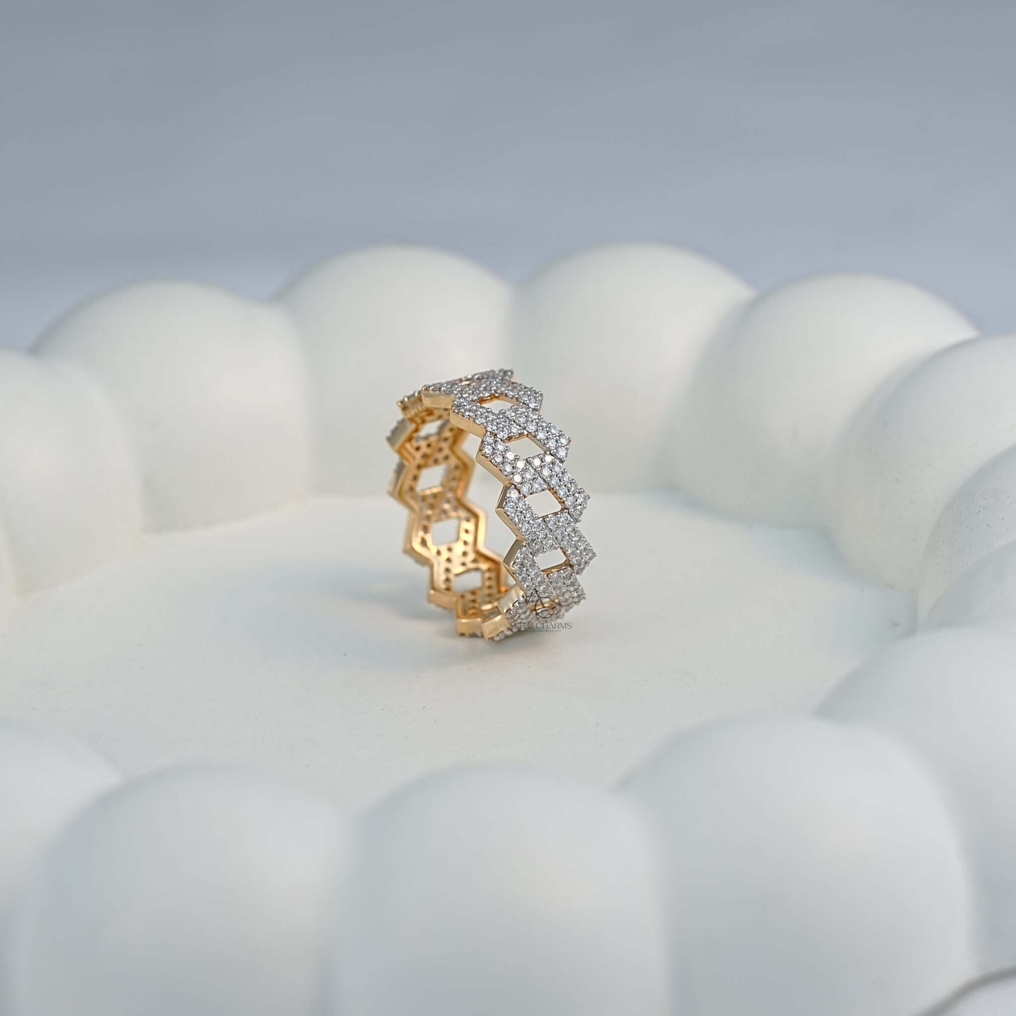 Side profile of a gold zigzag diamond band placed elegantly on a white display.