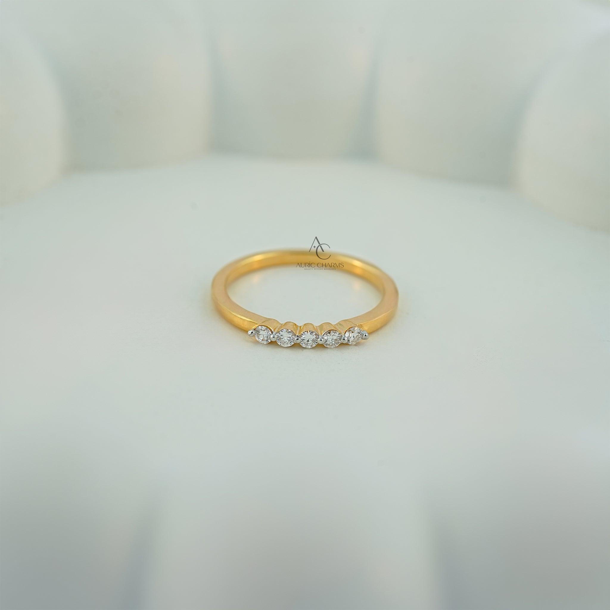 Delicate gold ring with diamonds on display, highlighting ethical and luxury craftsmanship.