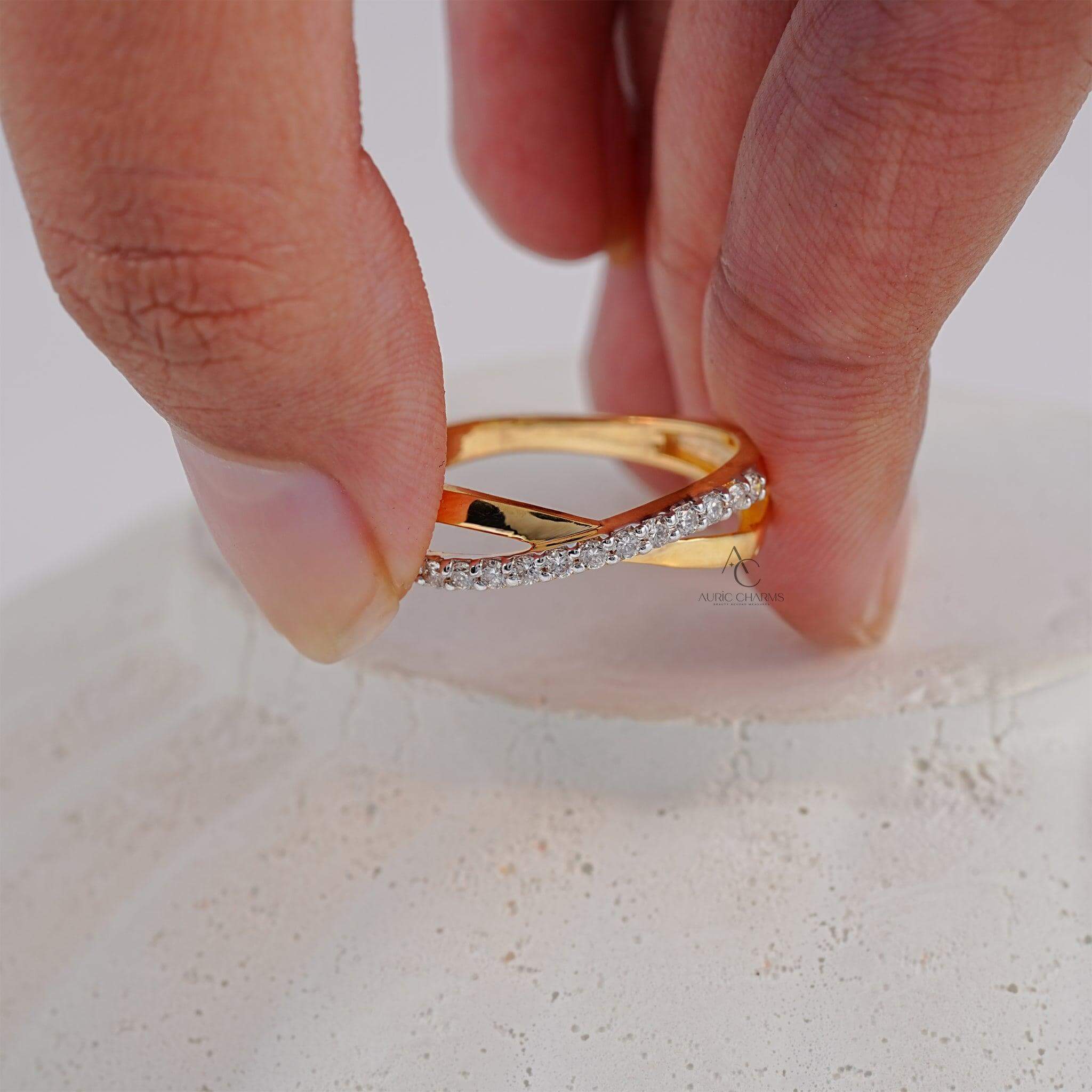 Gold crisscross ring adorned with diamonds, showcasing luxury and elegance.