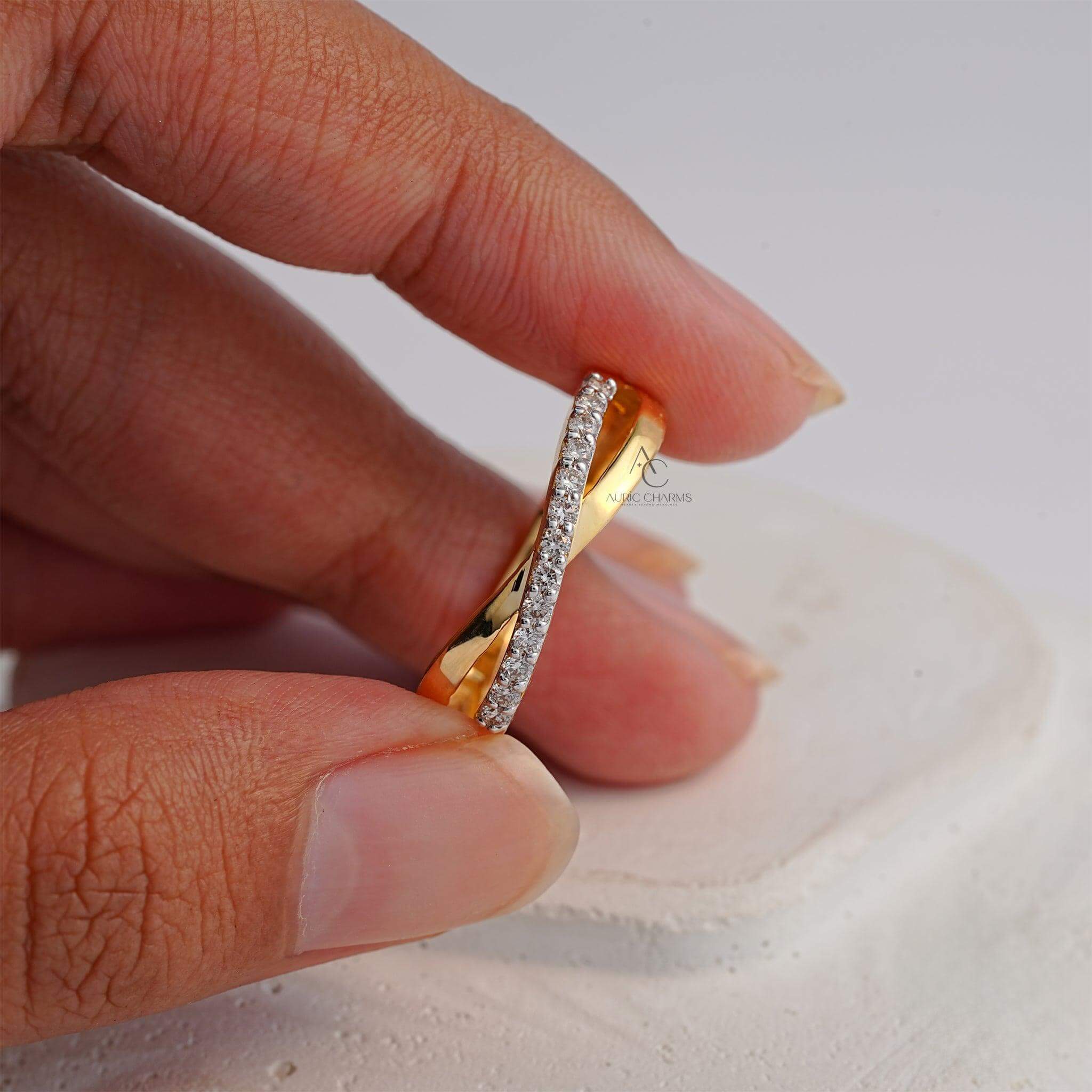 Back view of a gold ring with a crisscross diamond design, highlighting craftsmanship.