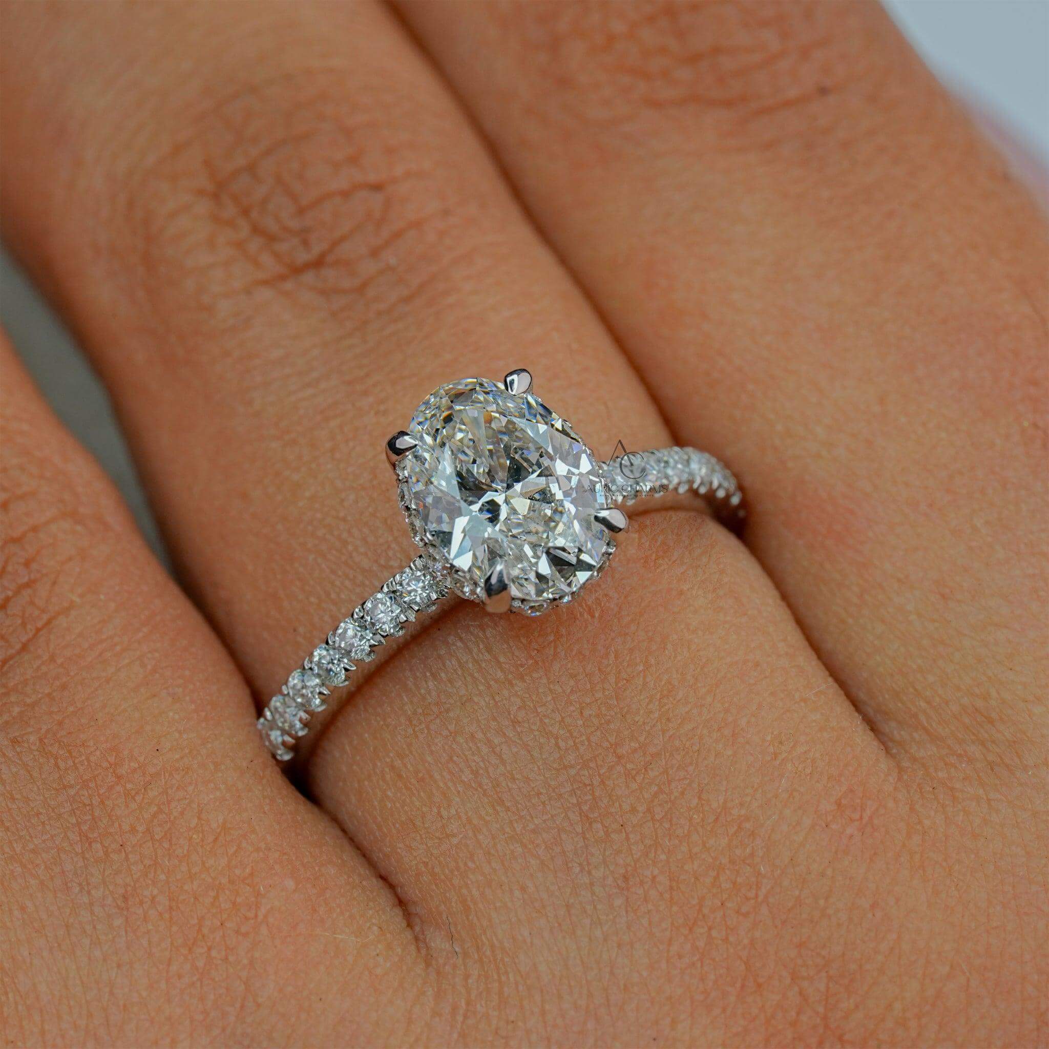 Oval diamond engagement ring elegantly displayed on a finger, radiating elegance.