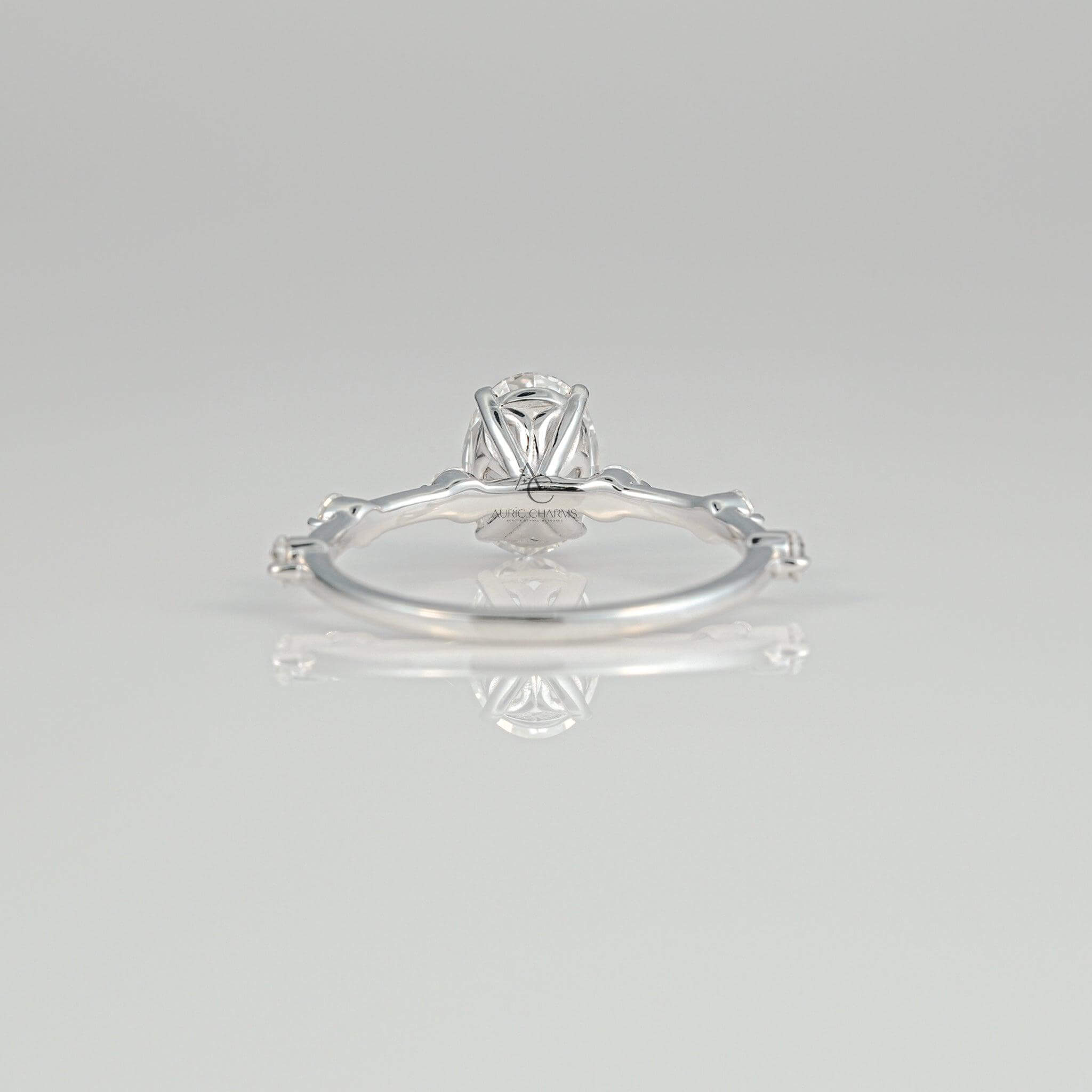 Profile view of an oval-cut diamond ring with a delicate setting, emphasizing its vintage-inspired design and sparkling diamonds on the shank.