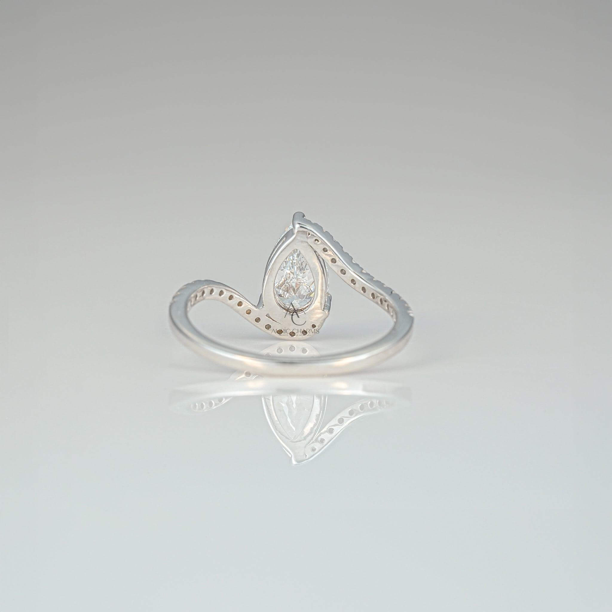 Rear view of a pear-shaped diamond ring showcasing the intricate swirl band.
