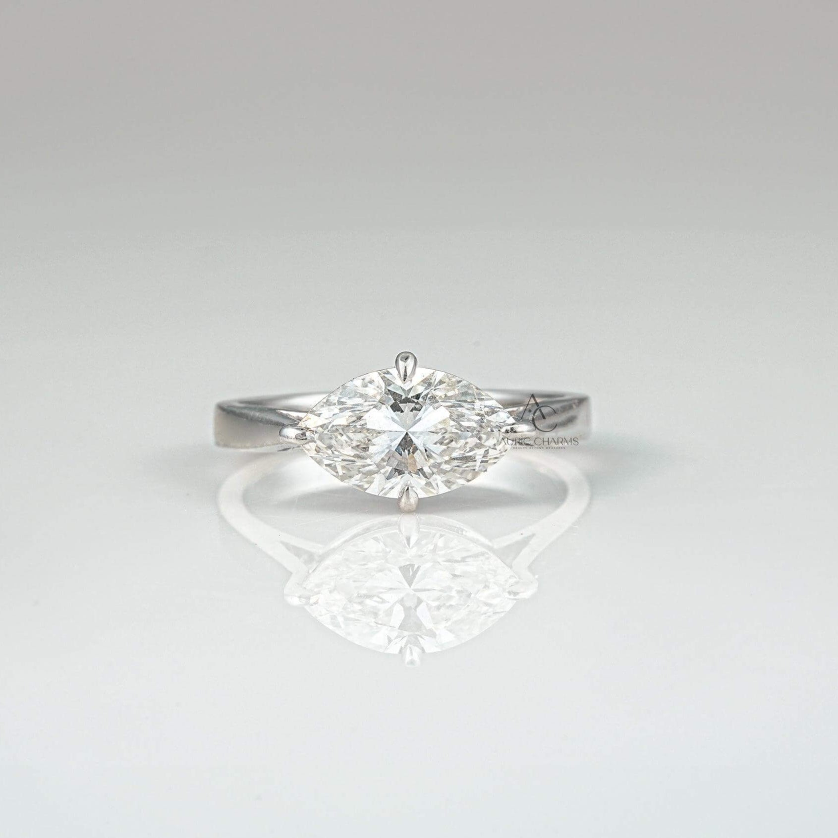 Marquise-cut diamond solitaire engagement ring with a sleek platinum band - front view.