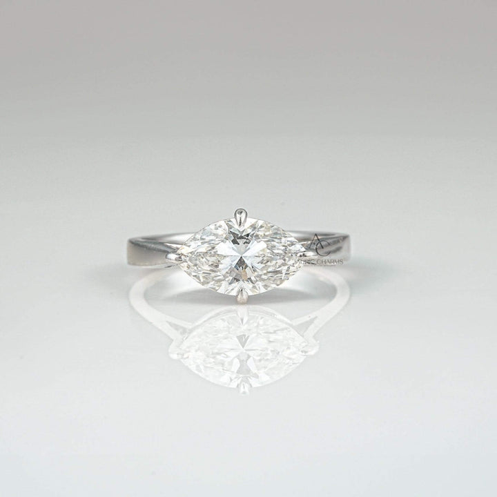 Marquise-cut diamond solitaire engagement ring with a sleek platinum band - front view.