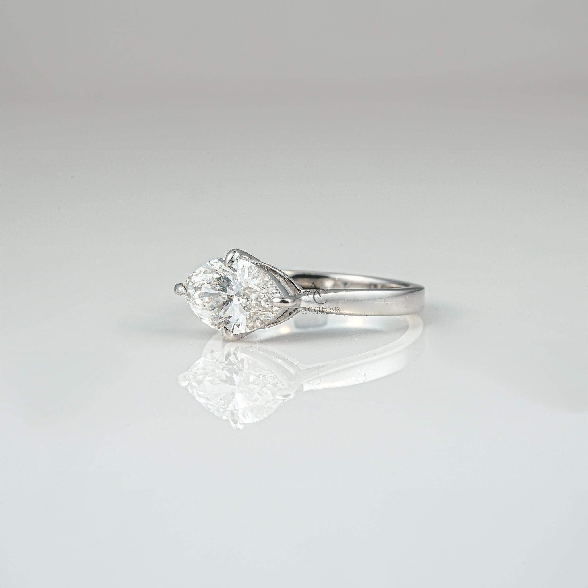 Side profile of a marquise-cut diamond solitaire engagement ring in a classic platinum setting.