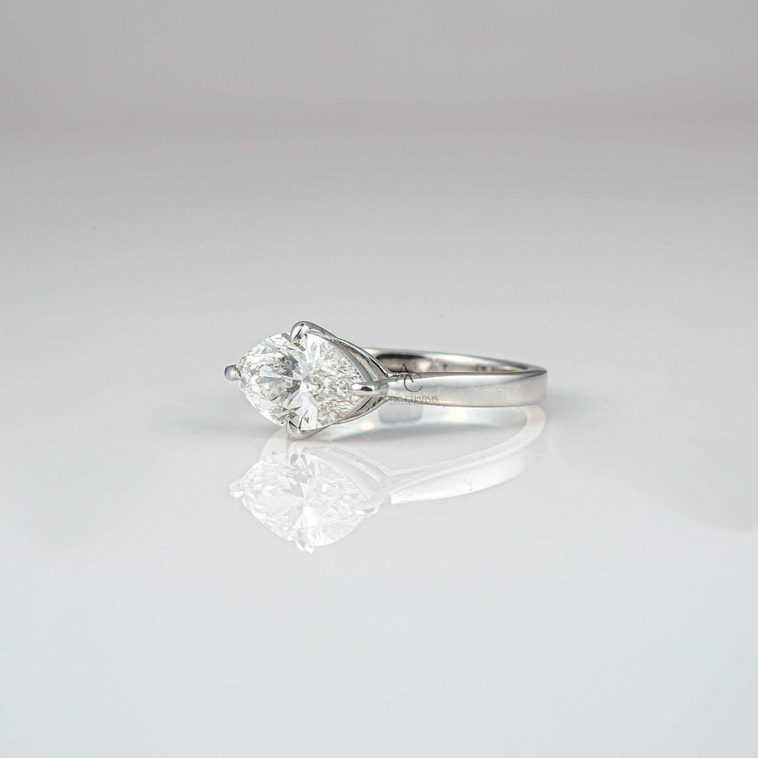 Side profile of a marquise-cut diamond solitaire engagement ring in a classic platinum setting.