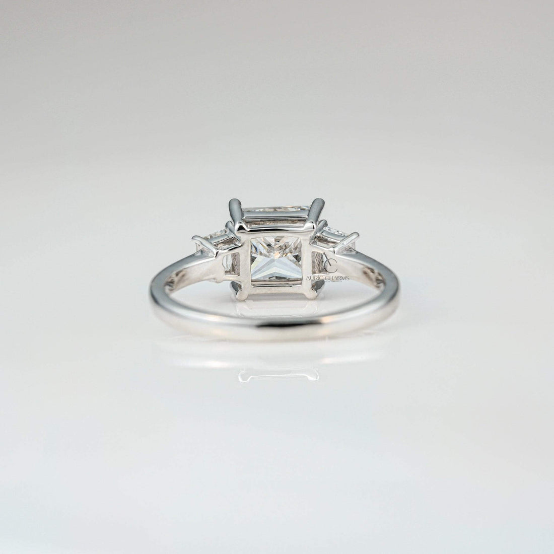 Back view of princess-cut diamond ring highlighting baguette accents in a sleek platinum band