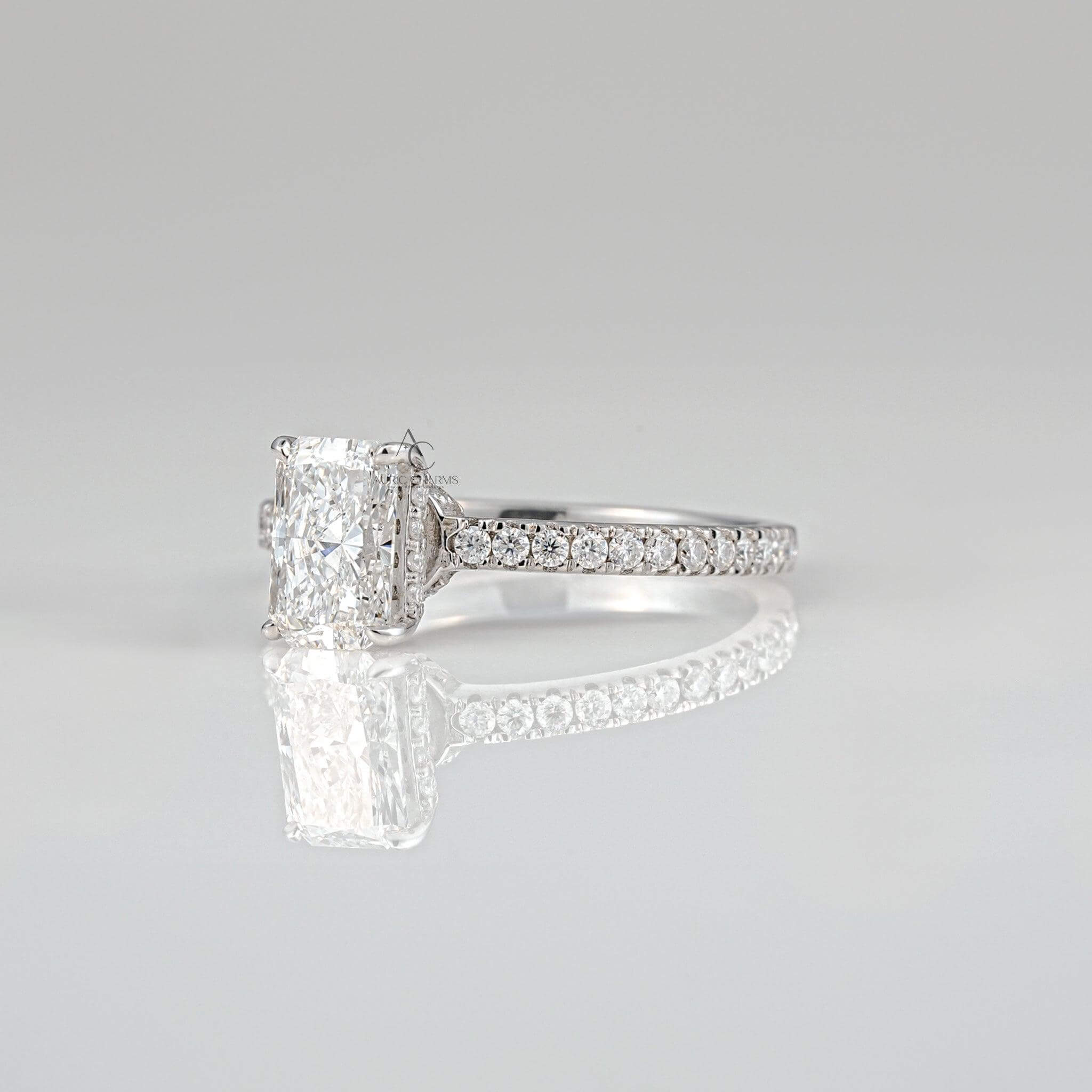Side view of radiant-cut diamond ring with intricate pavé detailing for timeless elegance.