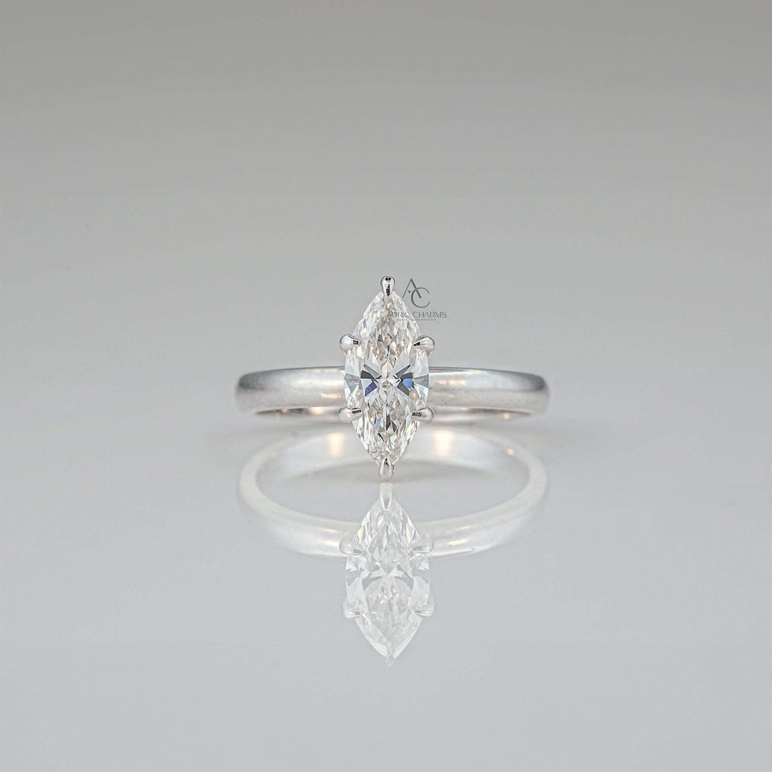 Front-facing view of a minimalist solitaire ring featuring a marquise-cut diamond set in a sleek, polished band with a timeless design.