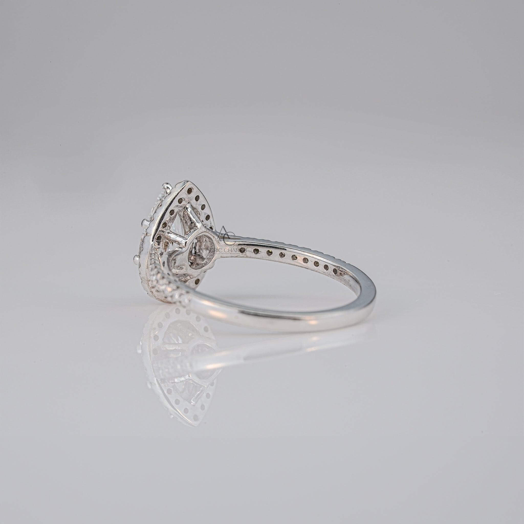 Side view of a pear-cut diamond ring with intricate detailing on the band.