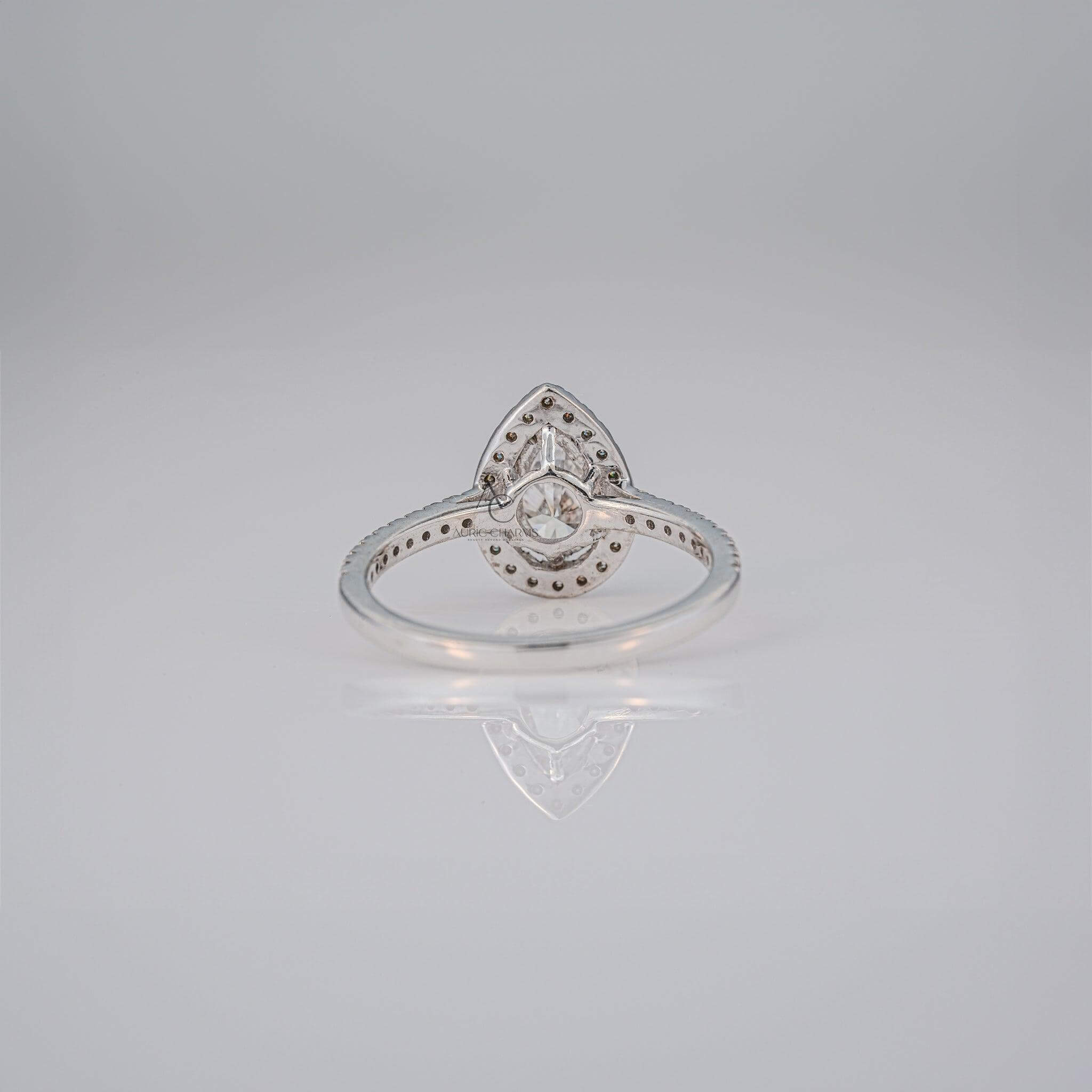 Rear view of a pear-cut diamond ring showcasing the setting and reflective band.