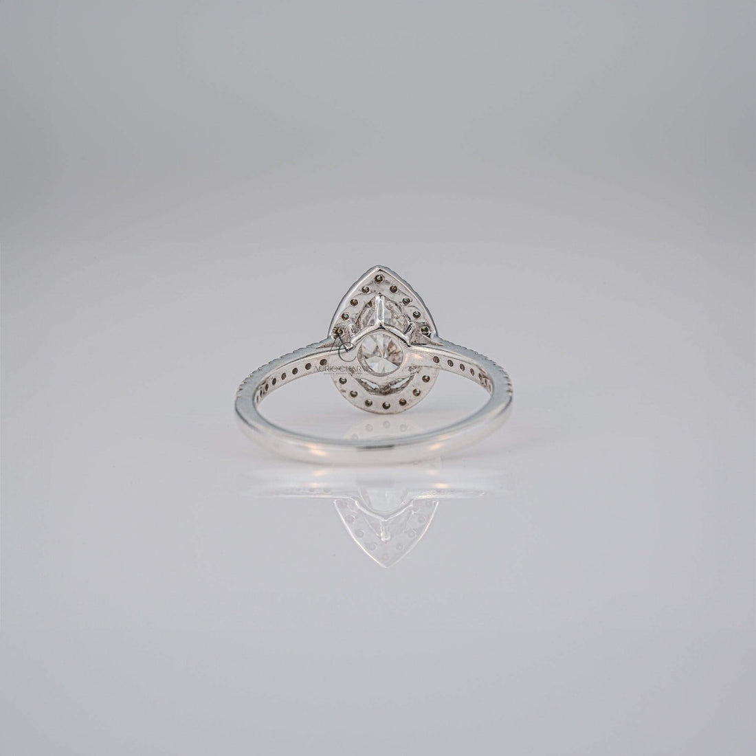 Rear view of a pear-cut diamond ring showcasing the setting and reflective band.