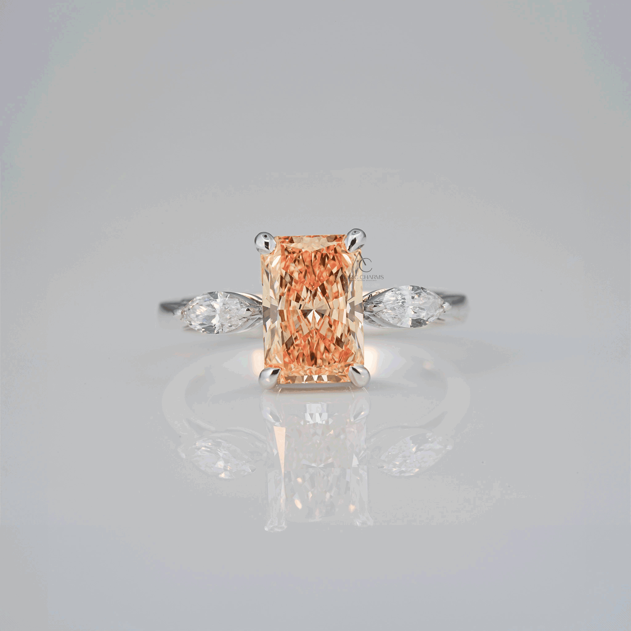 Radiant-cut champagne-colored lab-grown diamond ring with marquise side stones set in a white gold band, reflecting brilliance and eco-friendly elegance.