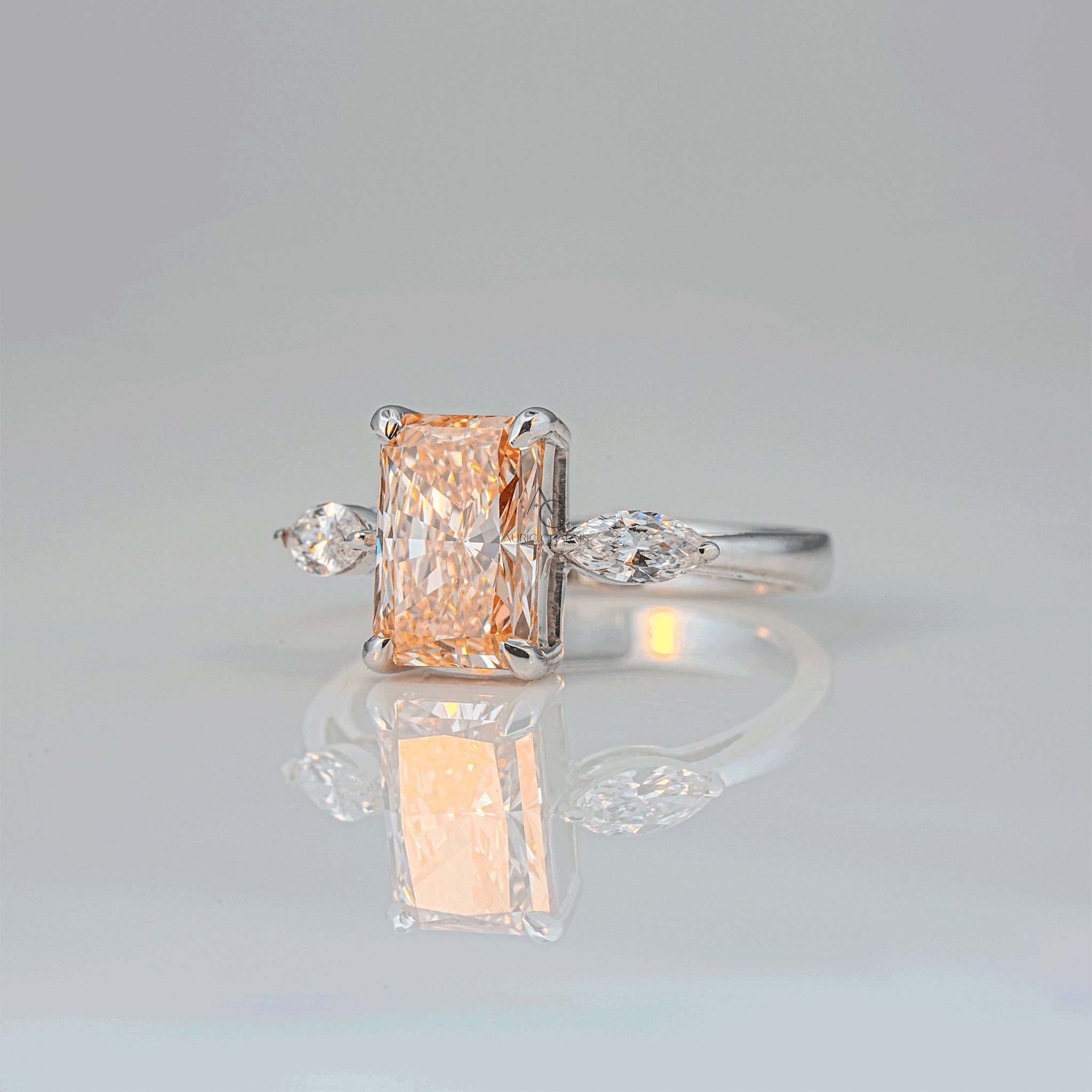 Side view of a radiant-cut champagne lab-grown diamond engagement ring featuring marquise side diamonds on a sleek white gold setting, ideal for sustainable luxury.