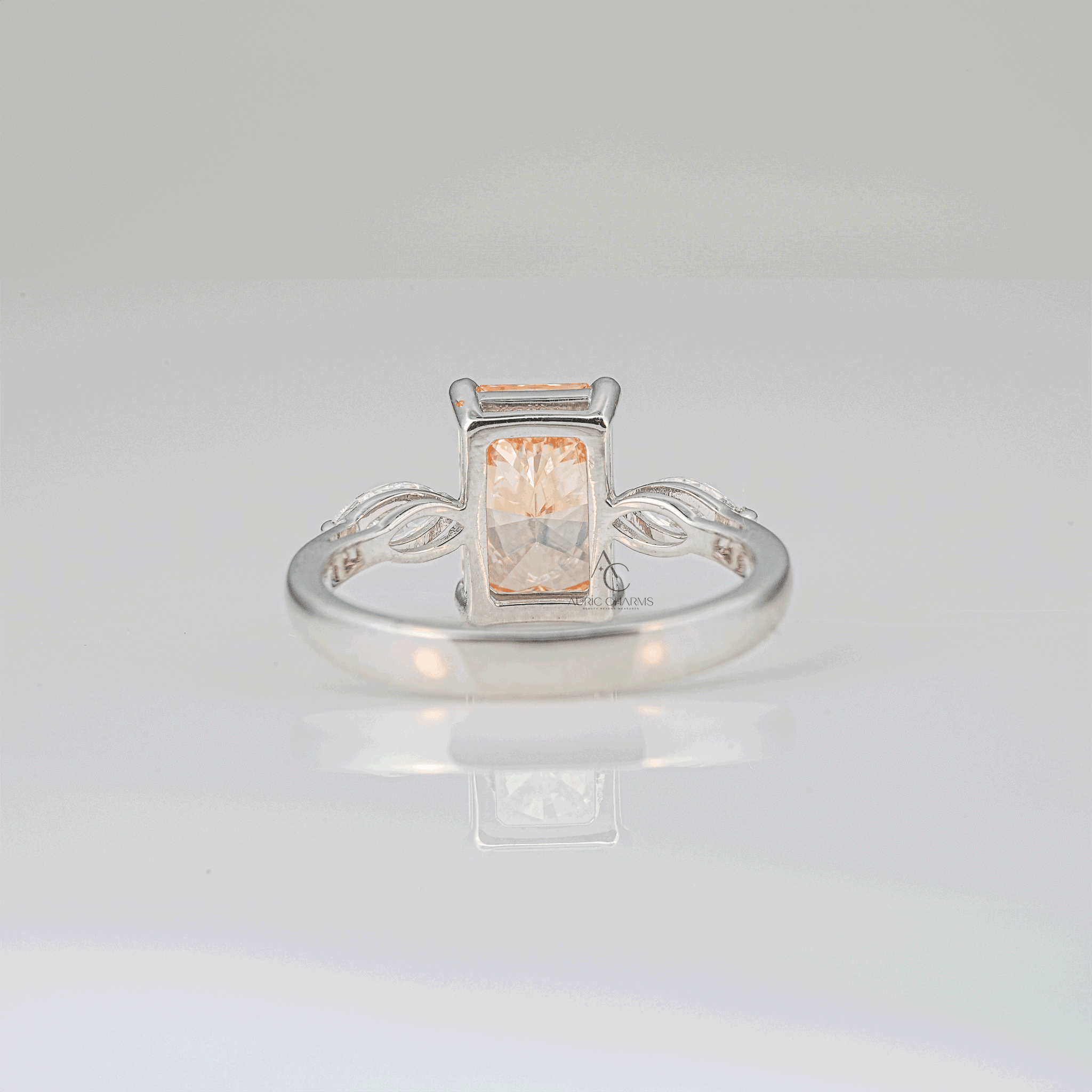 Rear angle showcasing the detailed craftsmanship of a radiant-cut champagne lab-grown diamond ring with marquise side stones in a white gold band.