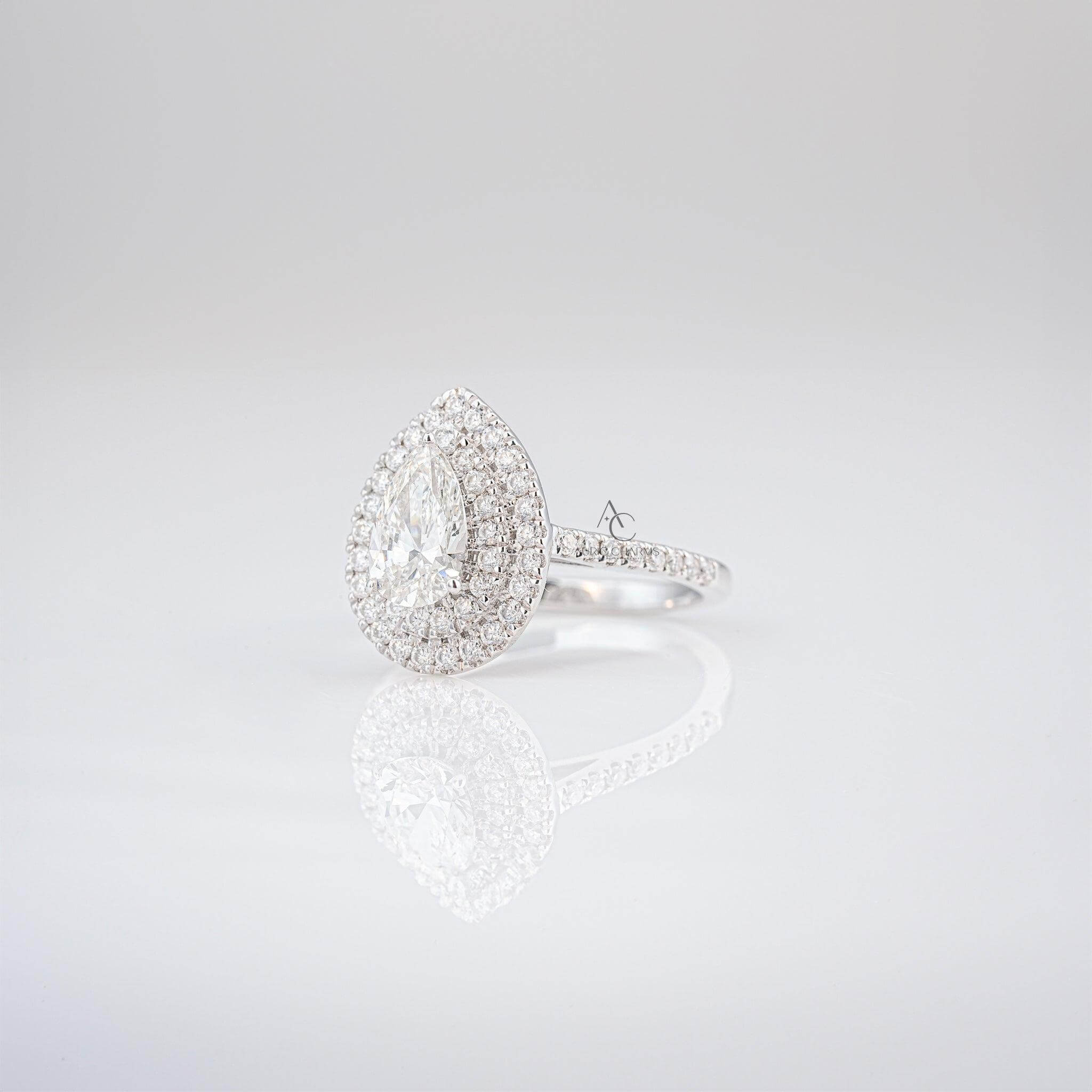 Side view of a pear-shaped diamond ring with a double halo and diamond band.