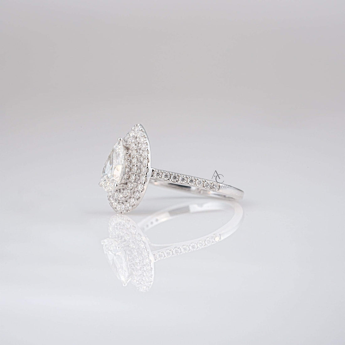 Profile of a pear-shaped diamond ring highlighting the layered double halo design.