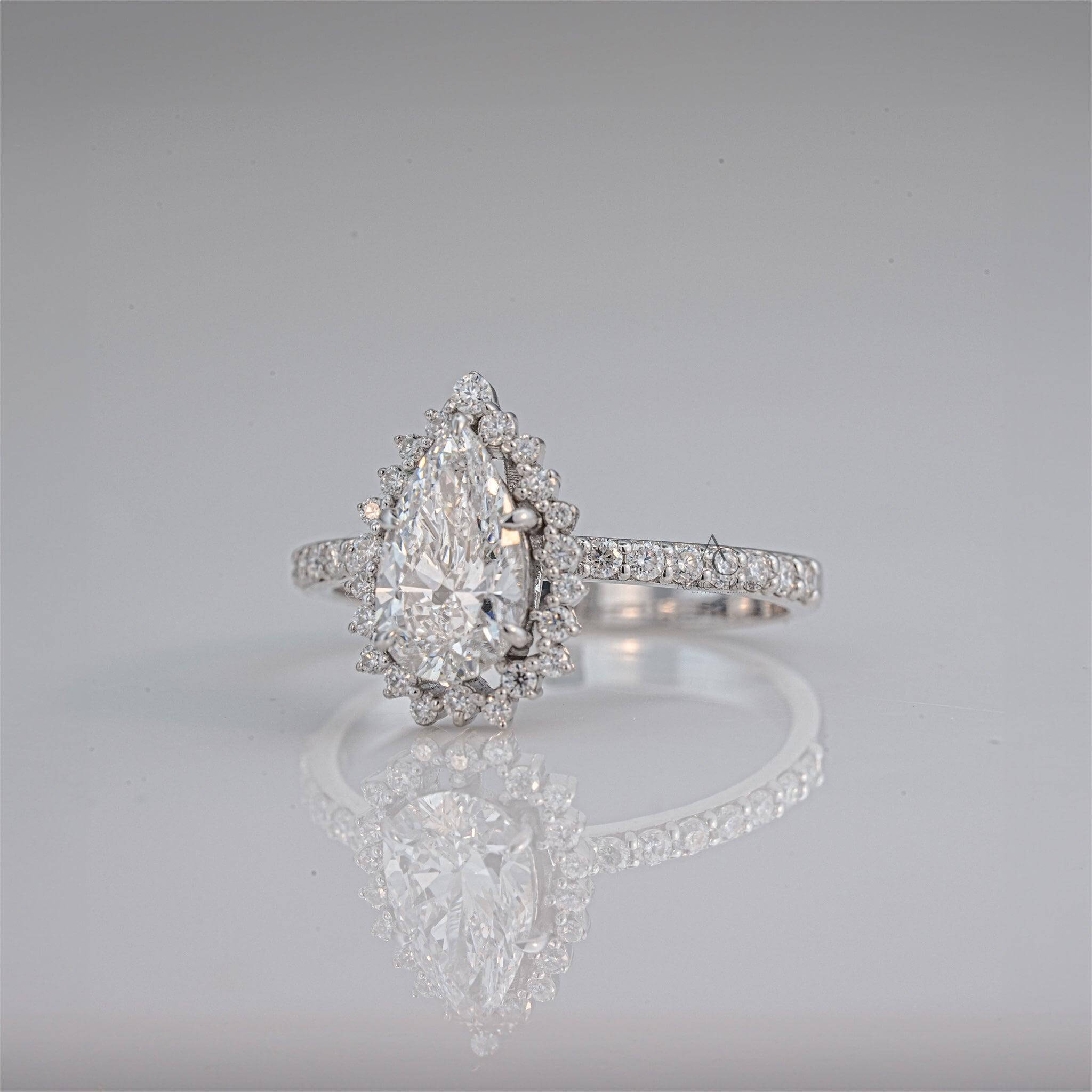 Side view of pear-shaped halo diamond ring featuring pave accents for added sparkle.