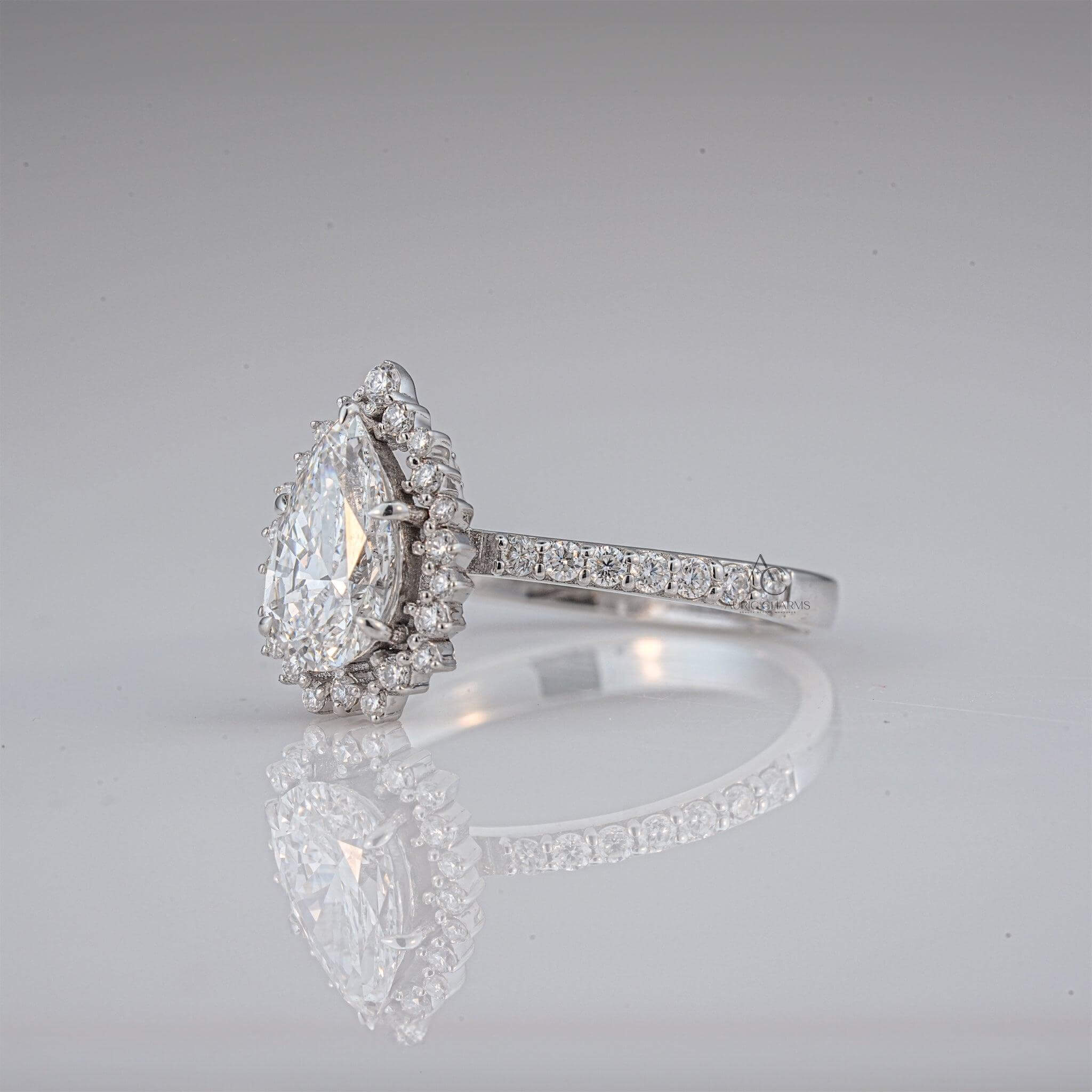 Elegant pear-shaped diamond engagement ring with a halo design and pave details.