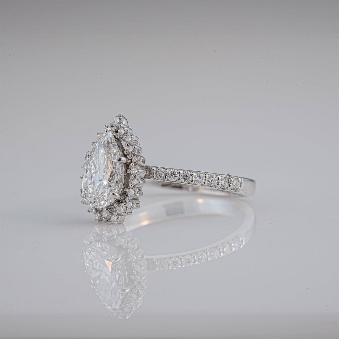 Profile of pear-shaped halo lab-grown diamond ring showcasing intricate pave band craftsmanship