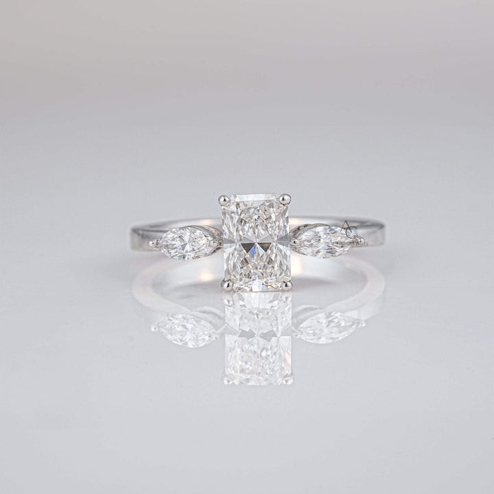Radiant cut lab-grown diamond ring with marquise side stones in a sleek platinum band - perfect for sustainable luxury engagements.