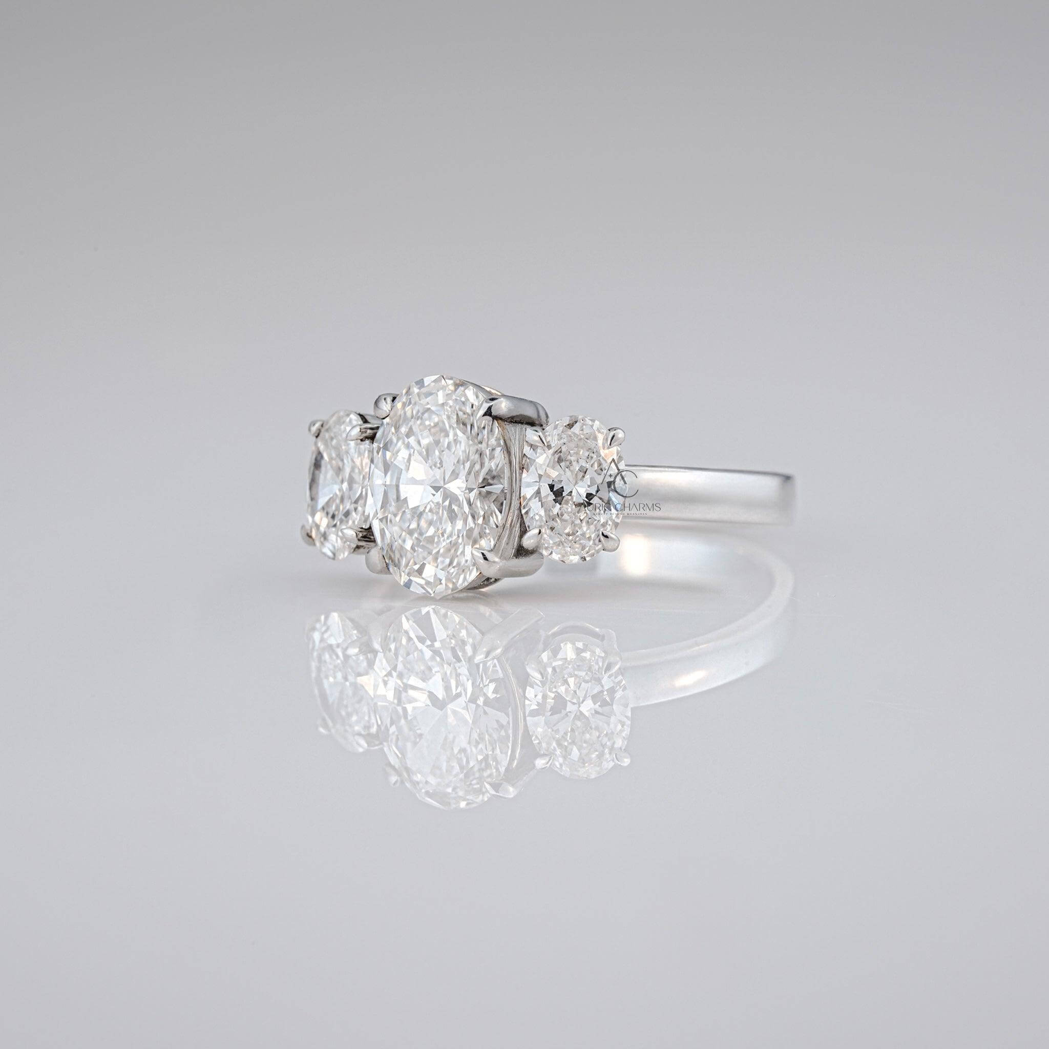 Angled view of oval lab-grown diamond ring with two side stones, set in a luxurious platinum band.