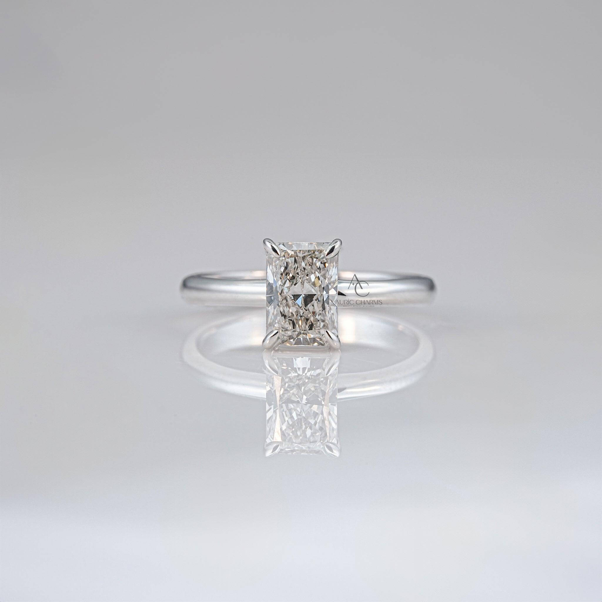 Radiant-cut diamond solitaire ring on sleek white gold band for timeless elegance.