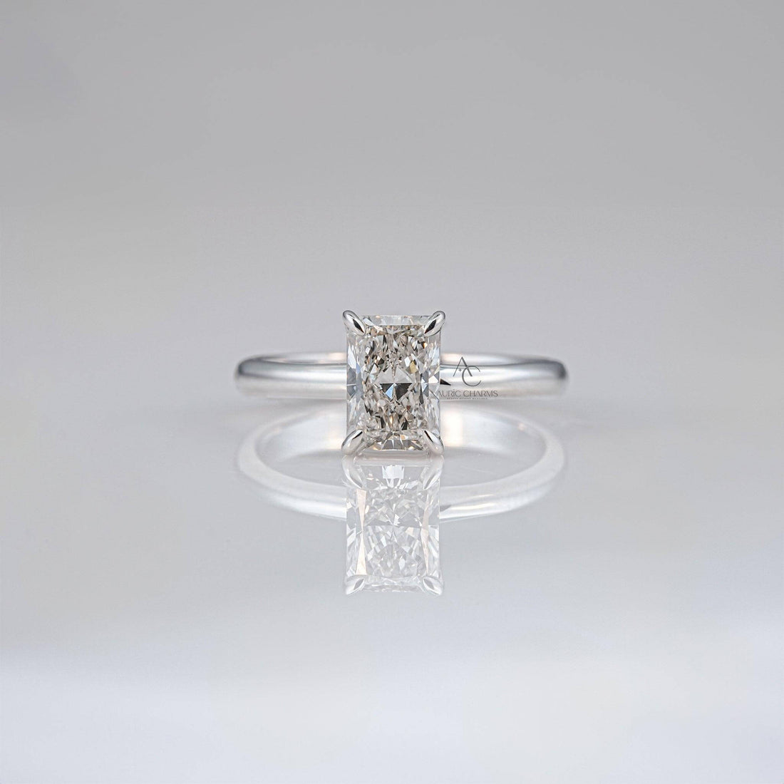 Radiant-cut diamond solitaire ring on sleek white gold band for timeless elegance.