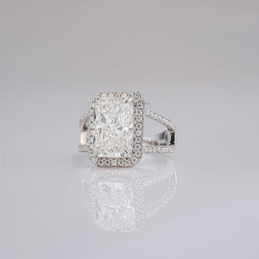 Side view of radiant-cut diamond halo ring with pave diamond band details.