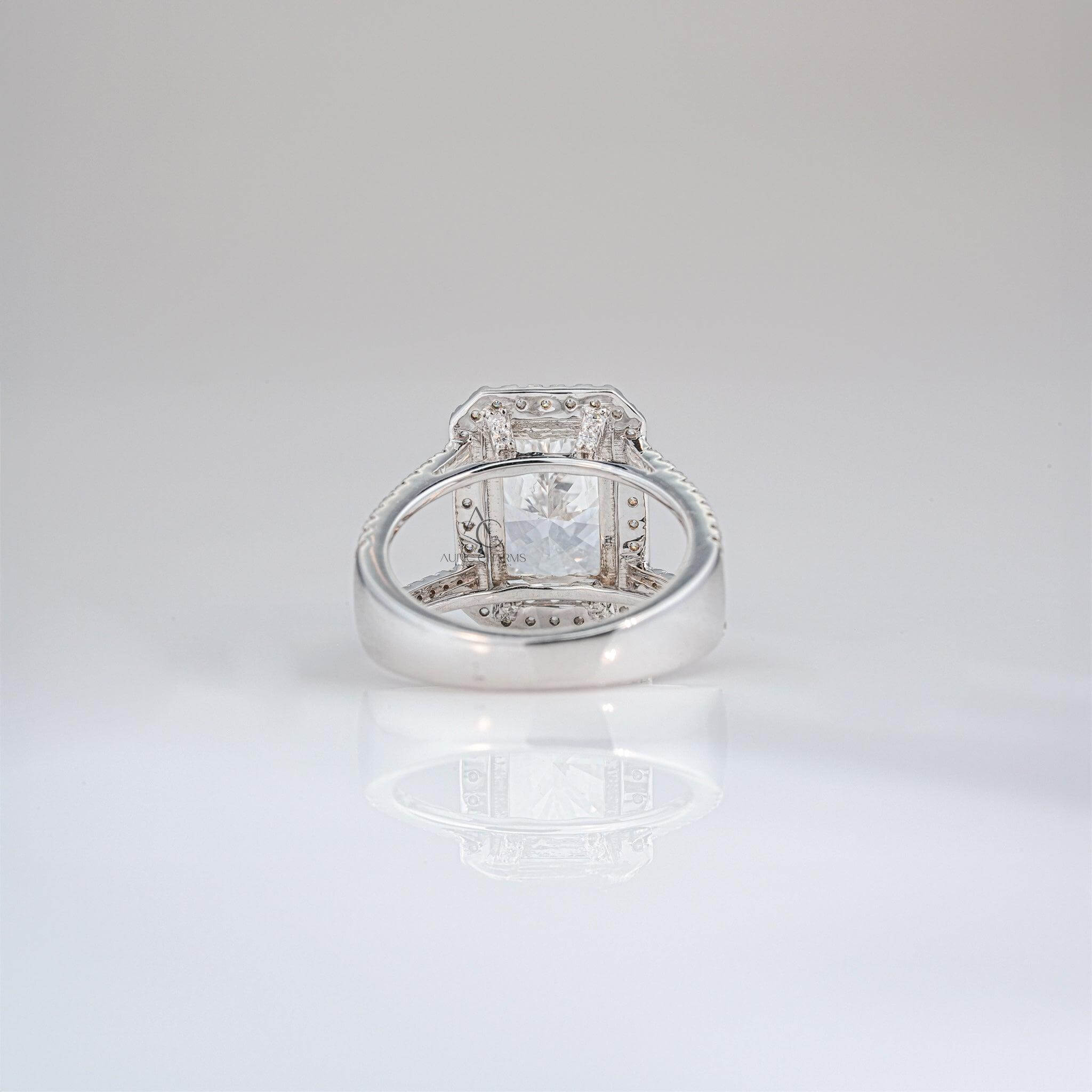 Radiant-cut diamond halo ring with split shank band adorned with diamonds.