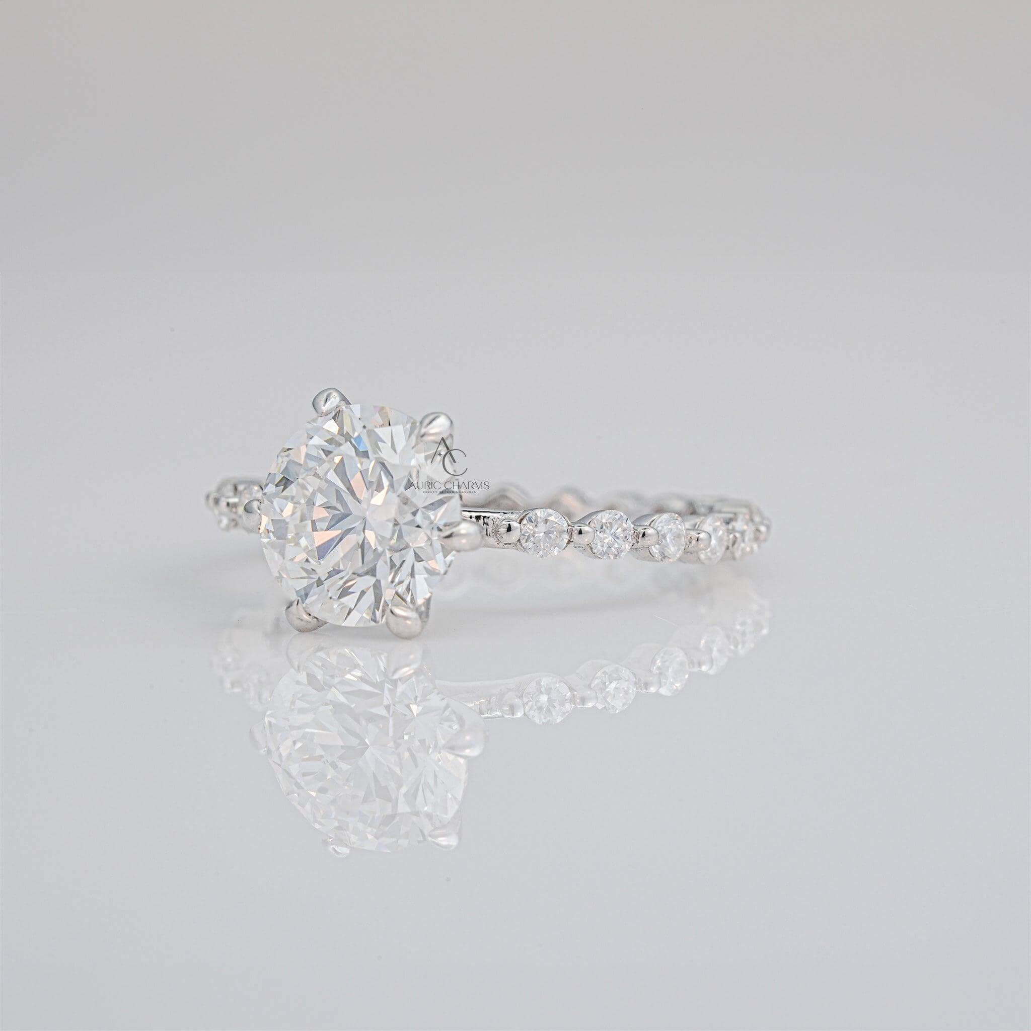 Lab-grown diamond solitaire engagement ring with shimmering pavé details.