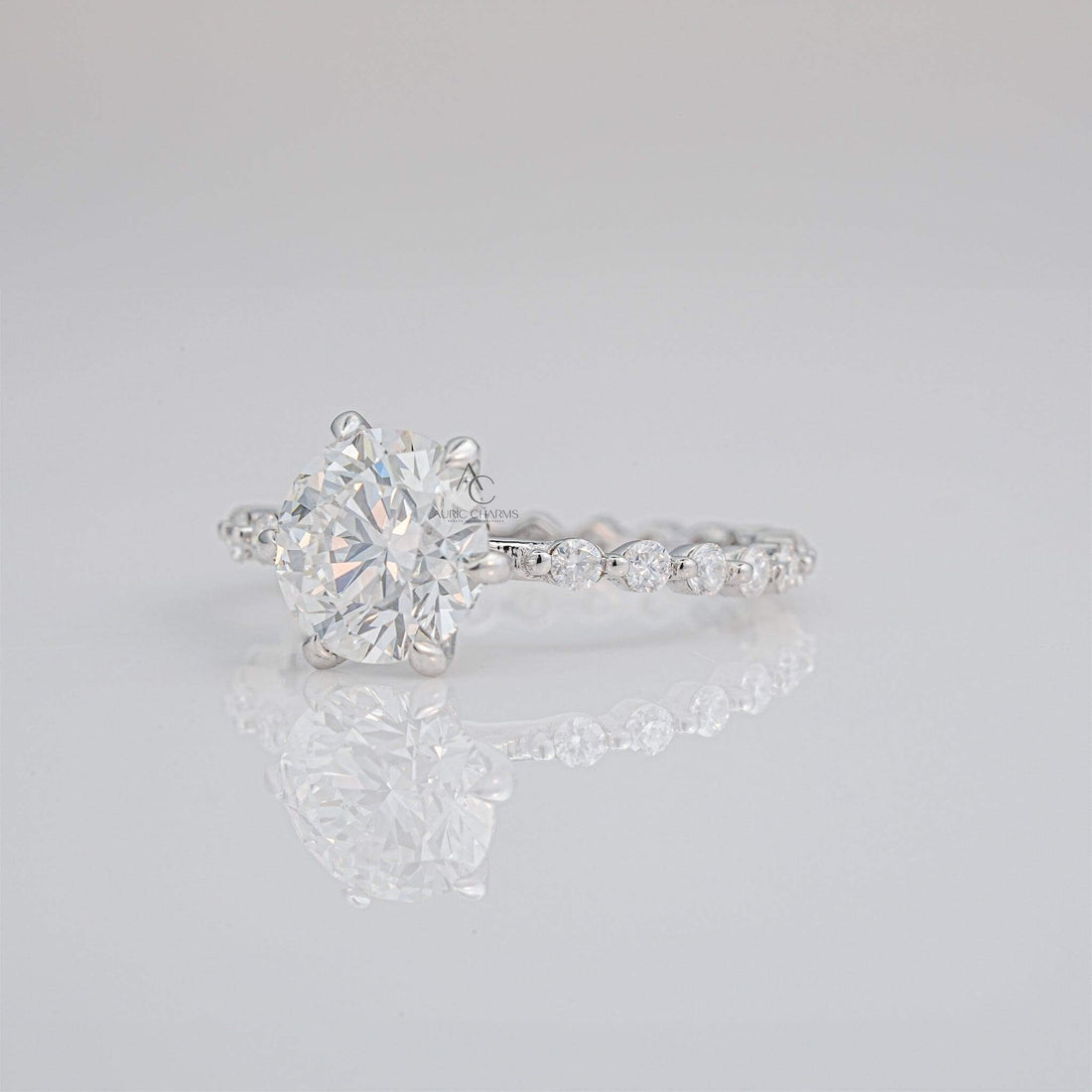 Lab-grown diamond solitaire engagement ring with shimmering pavé details.