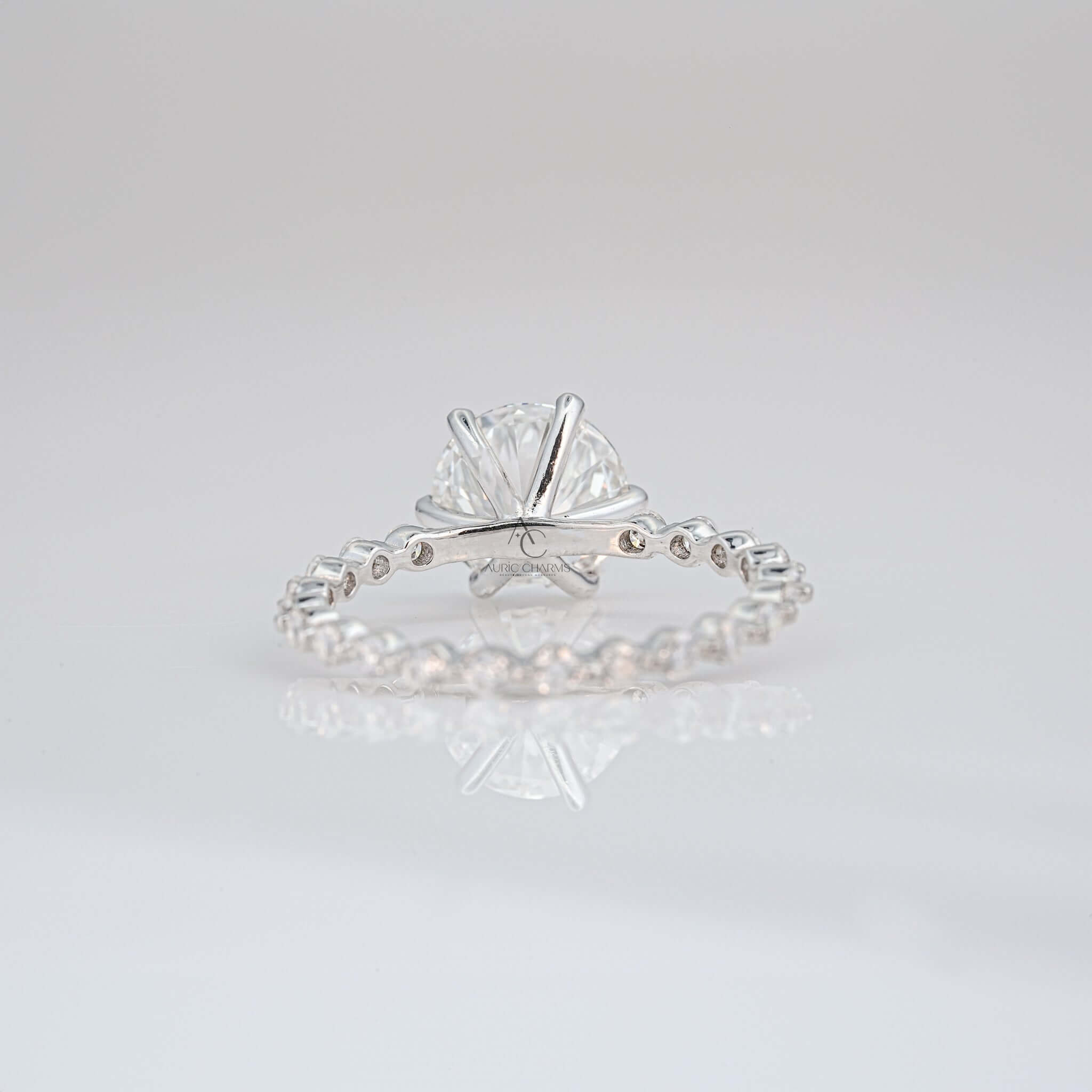 Back view of round diamond ring showing intricate prong and pave detailing.