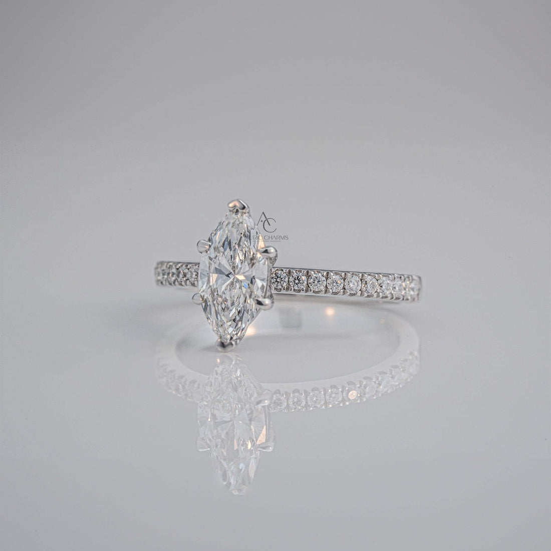 Side profile of a marquise-cut diamond ring with a sparkling pavé platinum band, showcasing its intricate craftsmanship.