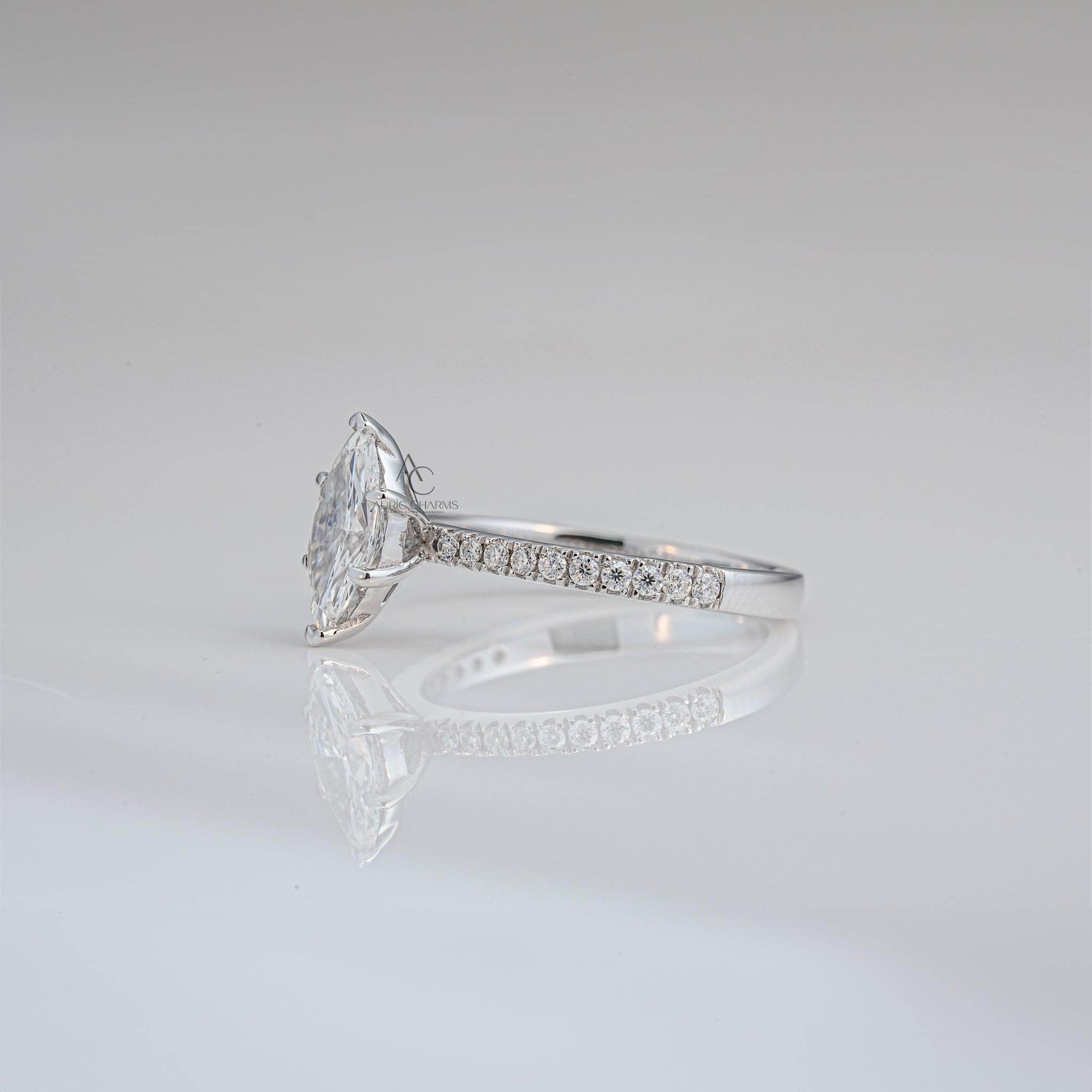 Close-up angled view of a marquise-cut diamond engagement ring with pavé accents, exuding timeless beauty.