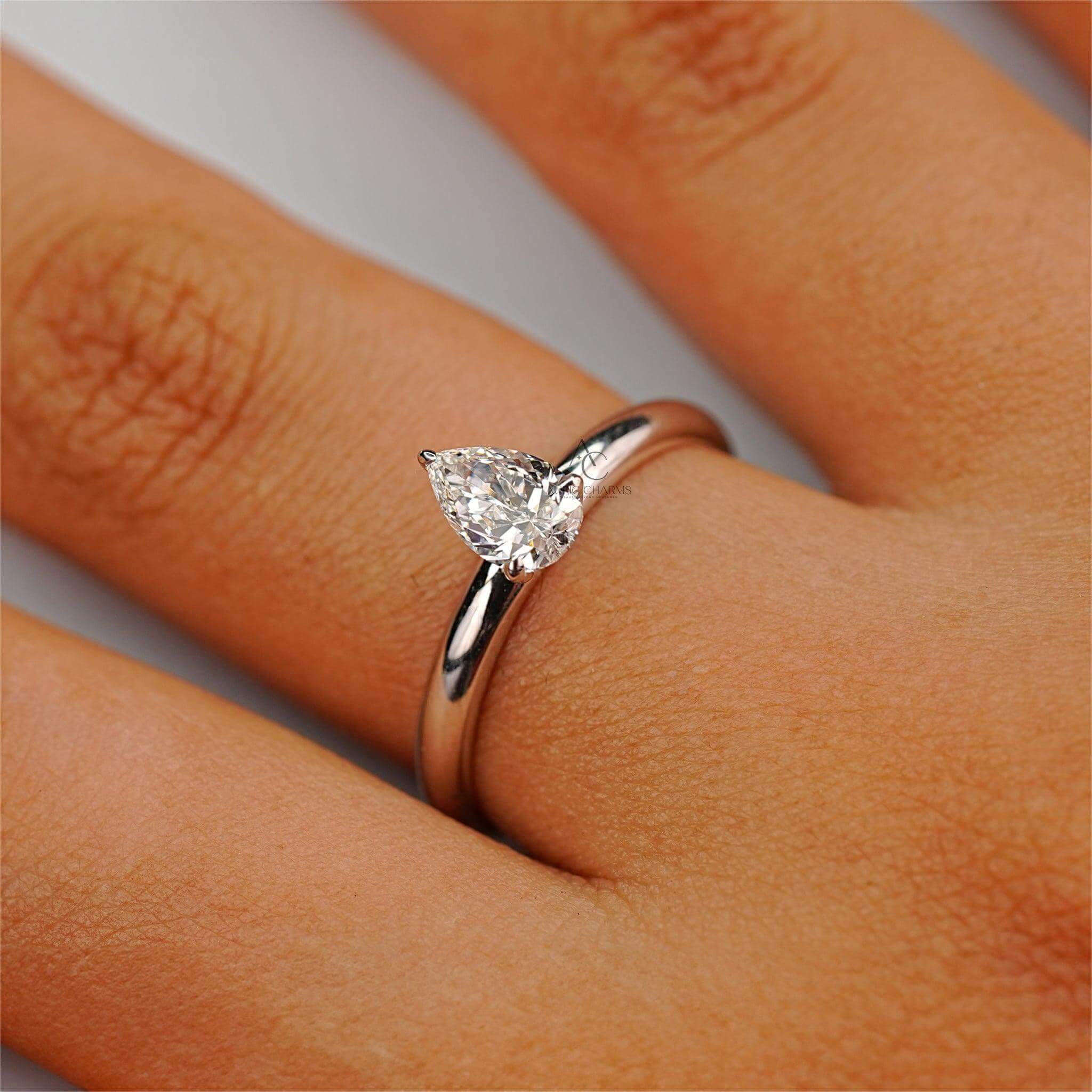 A radiant pear-cut lab-grown diamond solitaire ring on a finger, illustrating its elegant design and perfect fit for an engagement or special occasion